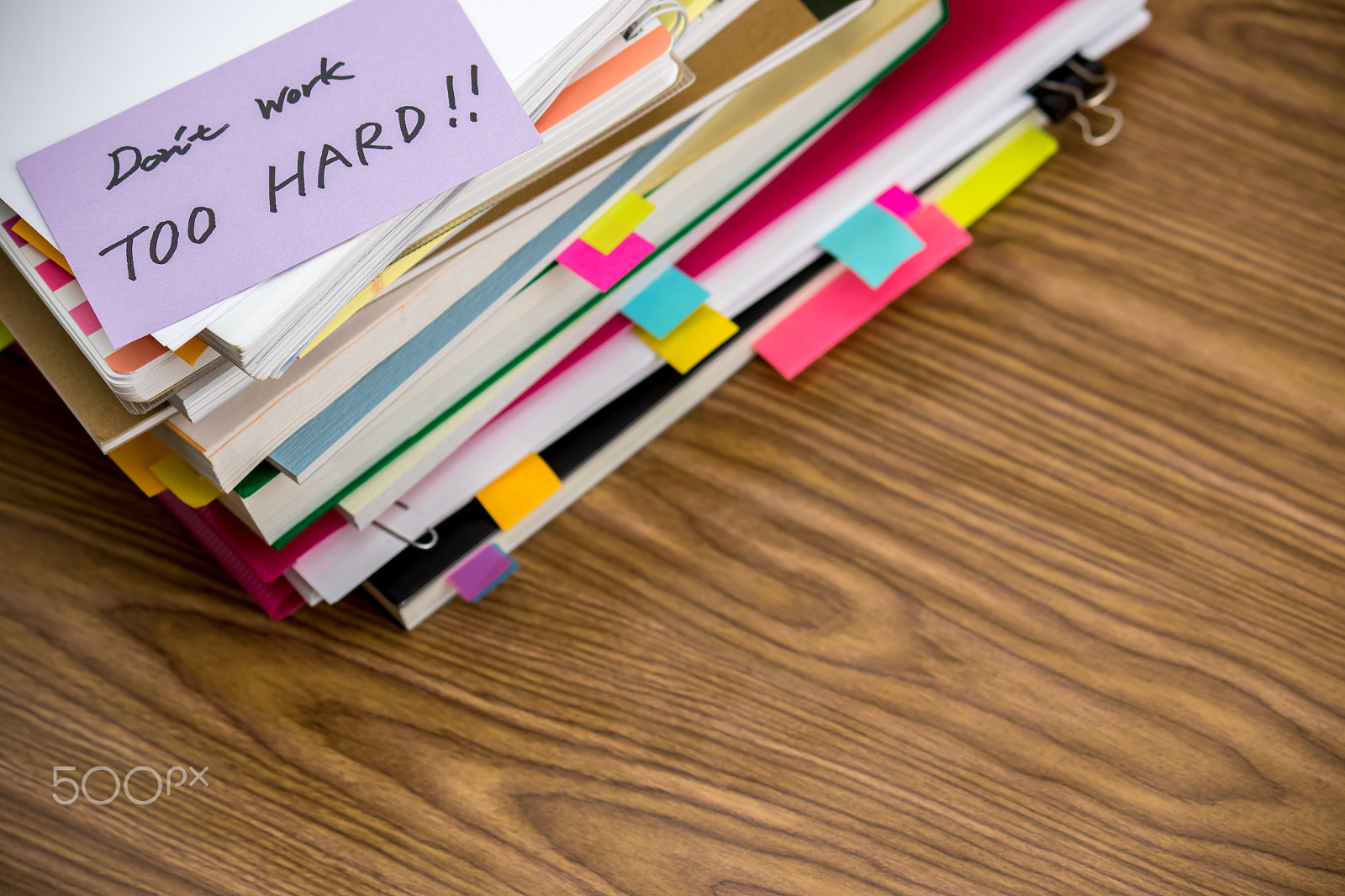 Canon EF-S 55-250mm F4-5.6 IS sample photo. Don't work too hard; the pile of business documents on the desk photography