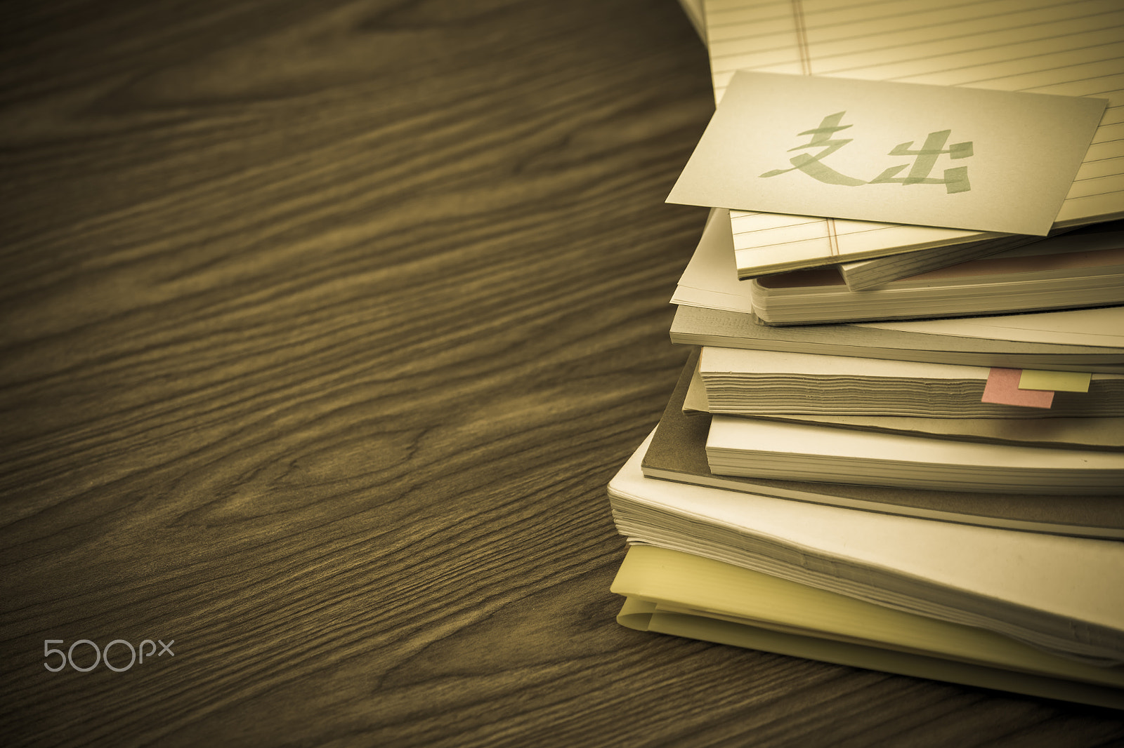 Canon EF-S 55-250mm F4-5.6 IS sample photo. Pay out; the pile of business documents on the desk photography