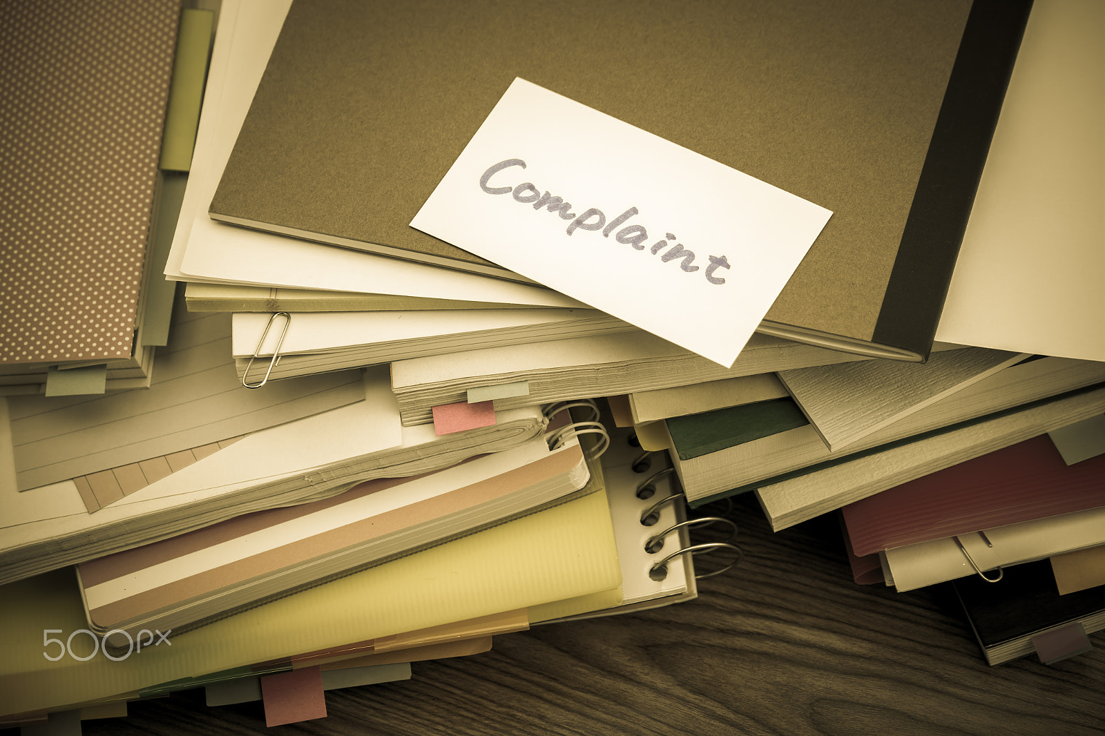 Canon EF-S 55-250mm F4-5.6 IS sample photo. Complaint; the pile of business documents on the desk photography