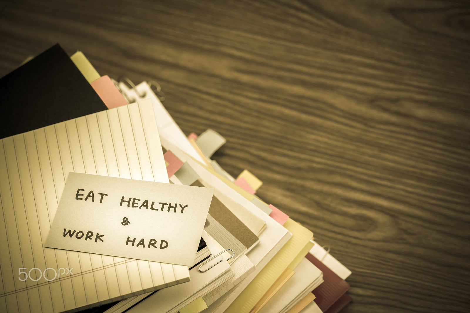 Canon EF-S 55-250mm F4-5.6 IS sample photo. Eat healthy work hard; the pile of business documents on the des photography