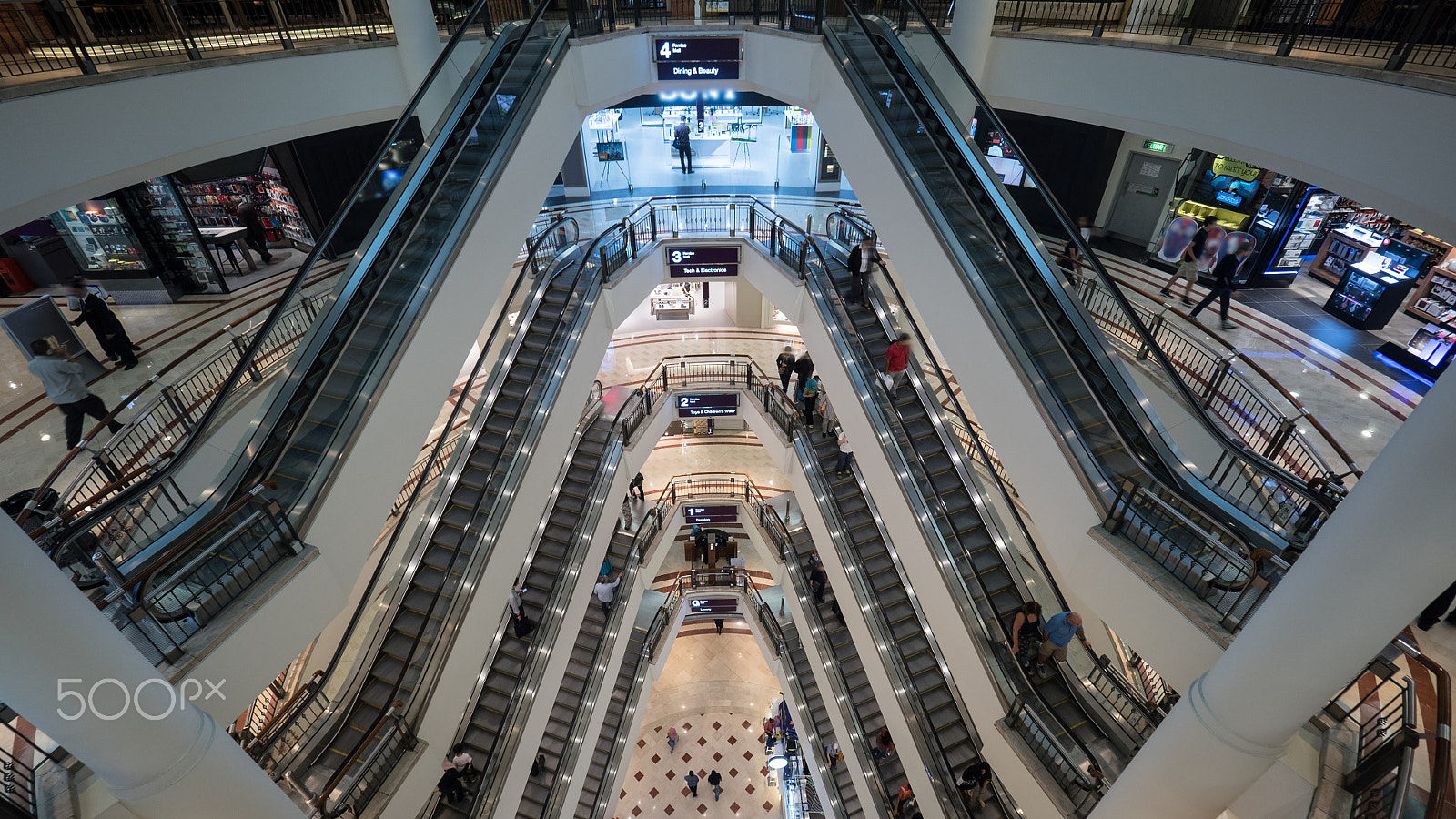 Panasonic Lumix DMC-GH4 + Olympus M.Zuiko Digital ED 7-14mm F2.8 PRO sample photo. People traffic in multistorey trade centre photography