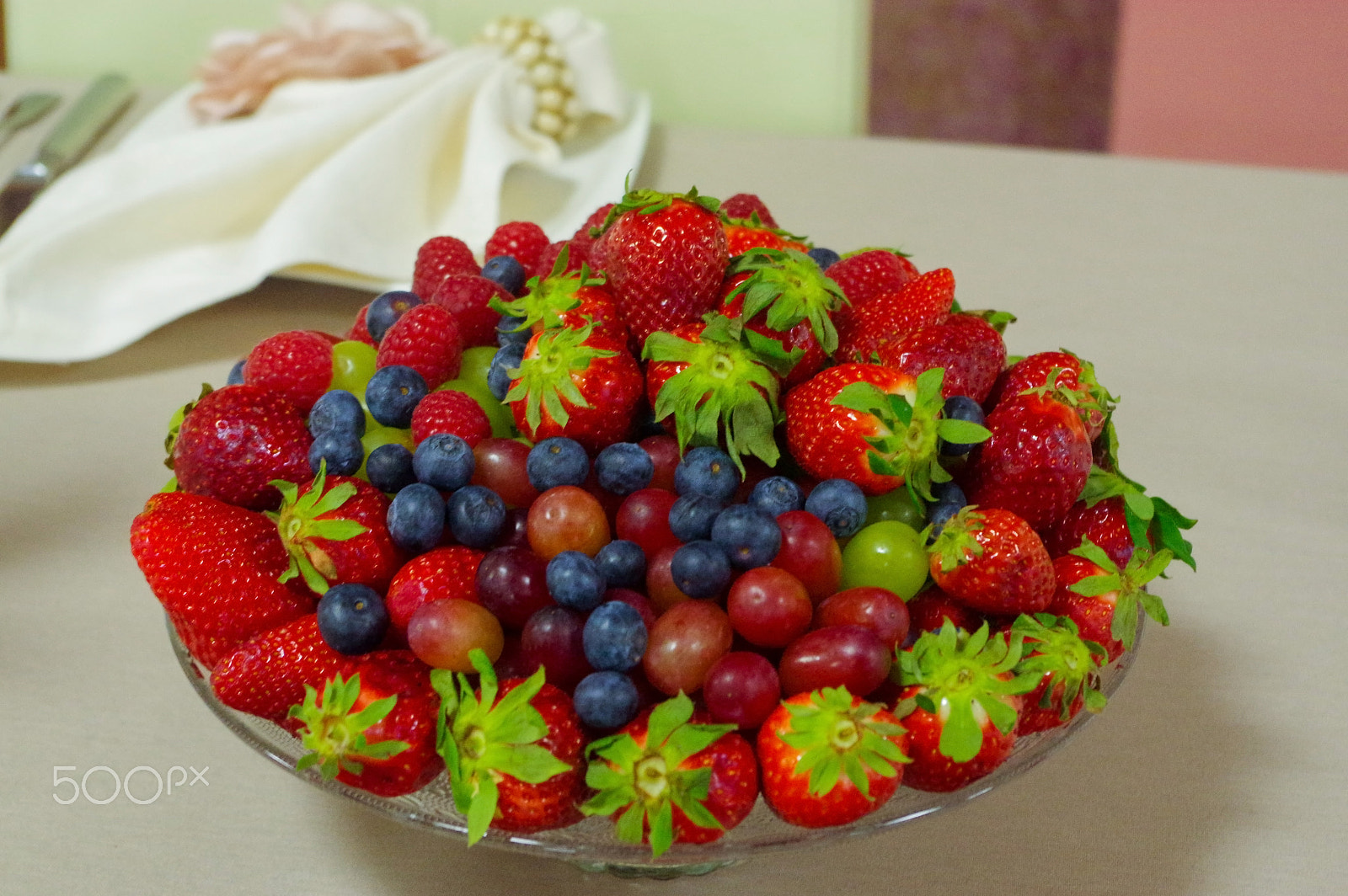Pentax K-3 sample photo. Fresh berries, blueberry, strawberry, raspberry in a glas bowl plate on gray table photography