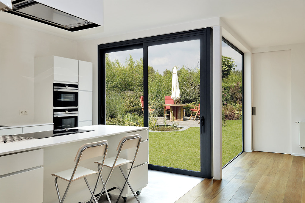 Modern luxery kitchen with view on a lush garden by Bombaert Patrick on 500px.com