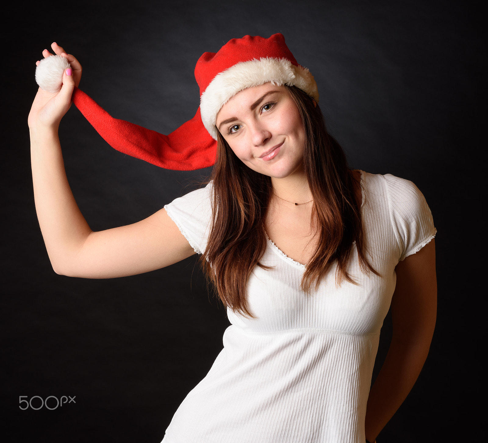 Nikon D810 + Nikon AF-S Nikkor 58mm F1.4G sample photo. Young girl with christmas santa hat isolated on black background photography