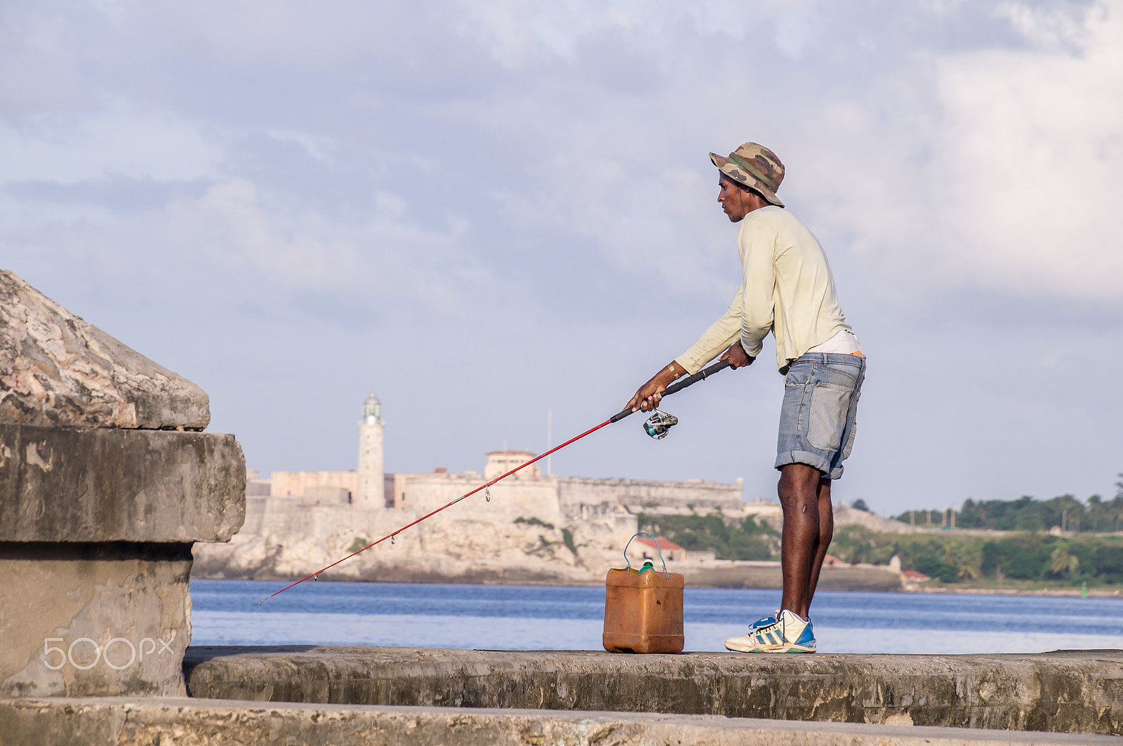 Sony SLT-A37 sample photo. Cuban fisherman with rod on malecon in front of castillo photography