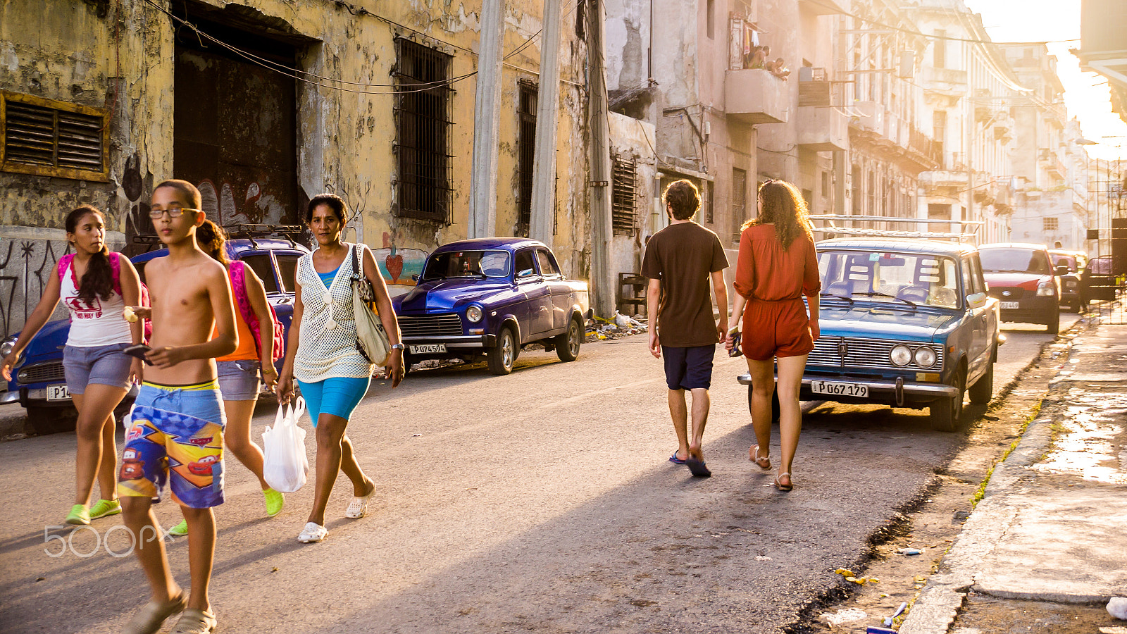 Sony SLT-A37 sample photo. Street scene of cuban people walking in old havana at sunset photography