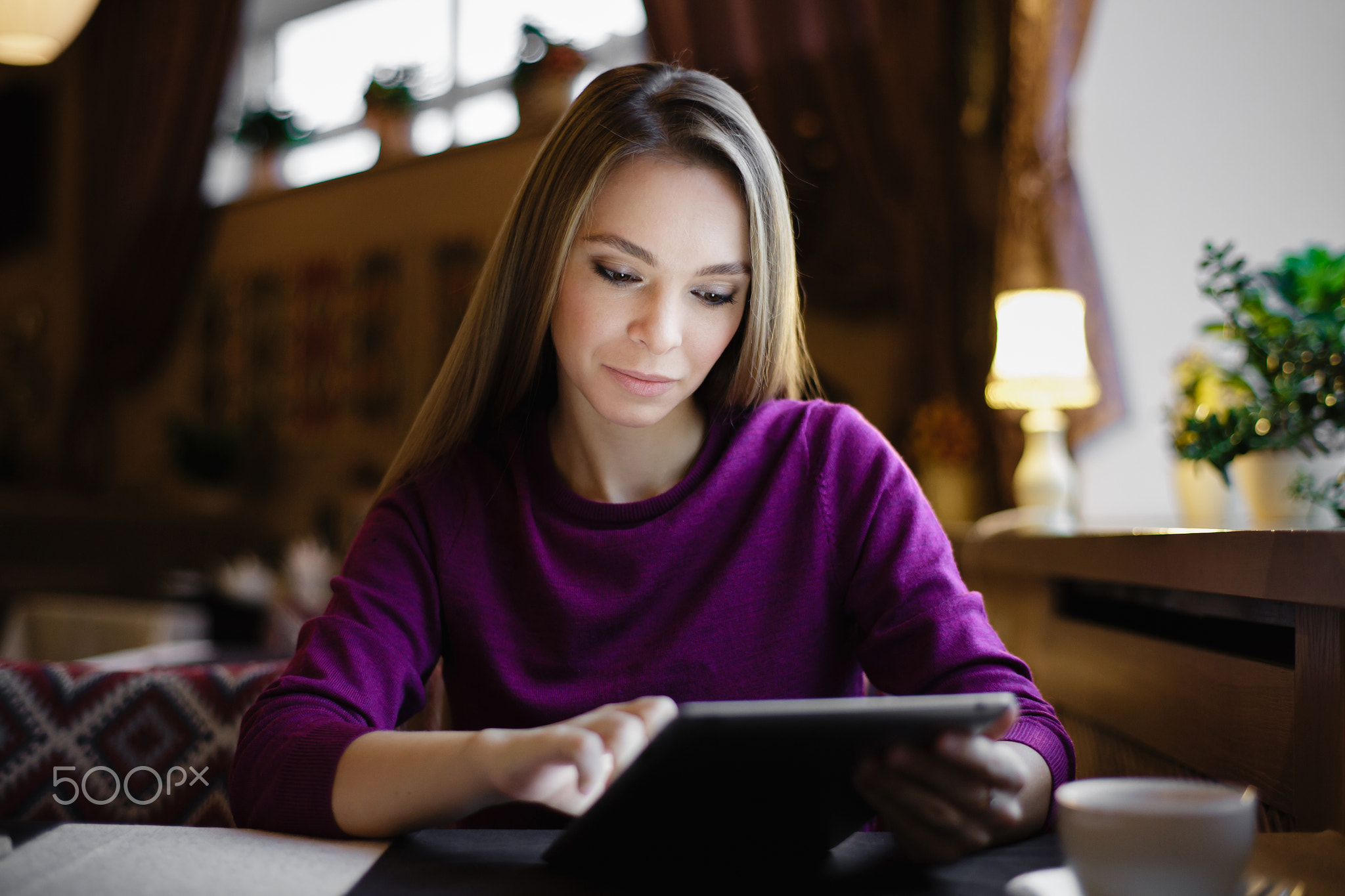 Young woman using tab