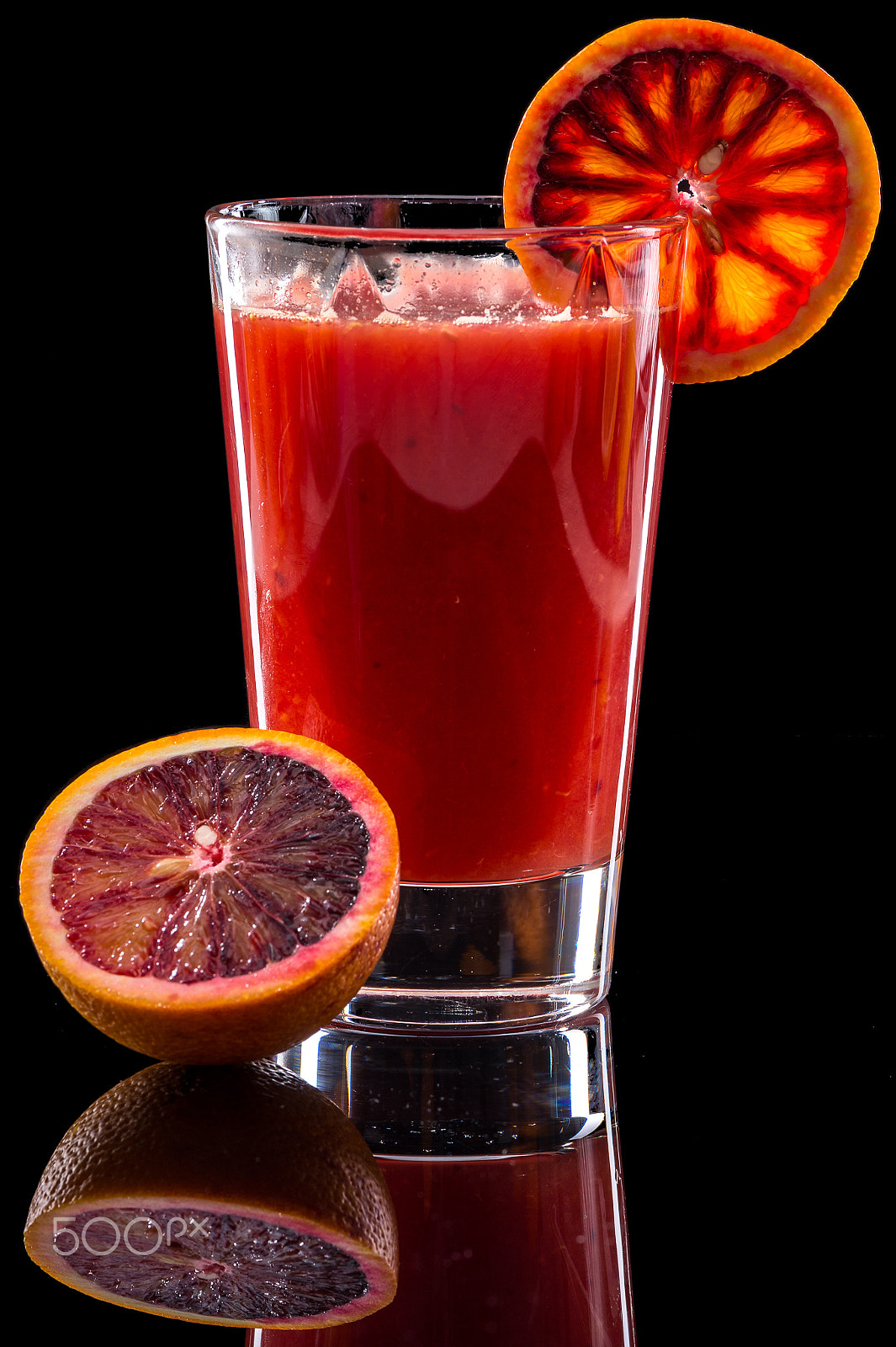 Nikon D4S sample photo. Orange juice isolated on a black background photography