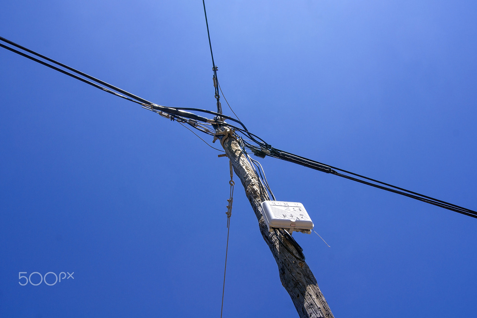 Sony Alpha DSLR-A500 sample photo. Wooden power pole with blue sky photography