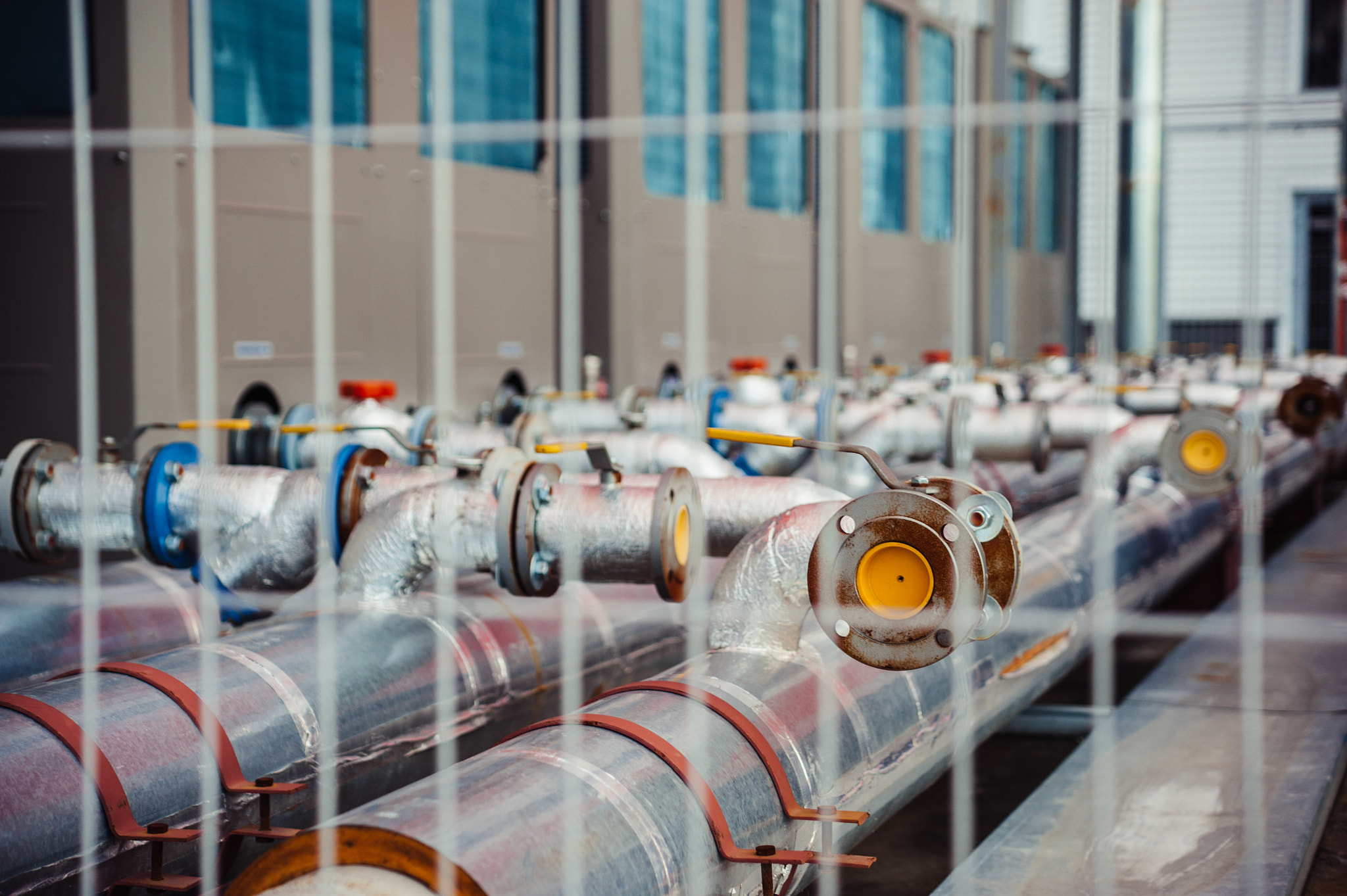 AF Zoom-Nikkor 35-135mm f/3.5-4.5 sample photo. Gas pipes behind a fence. photography