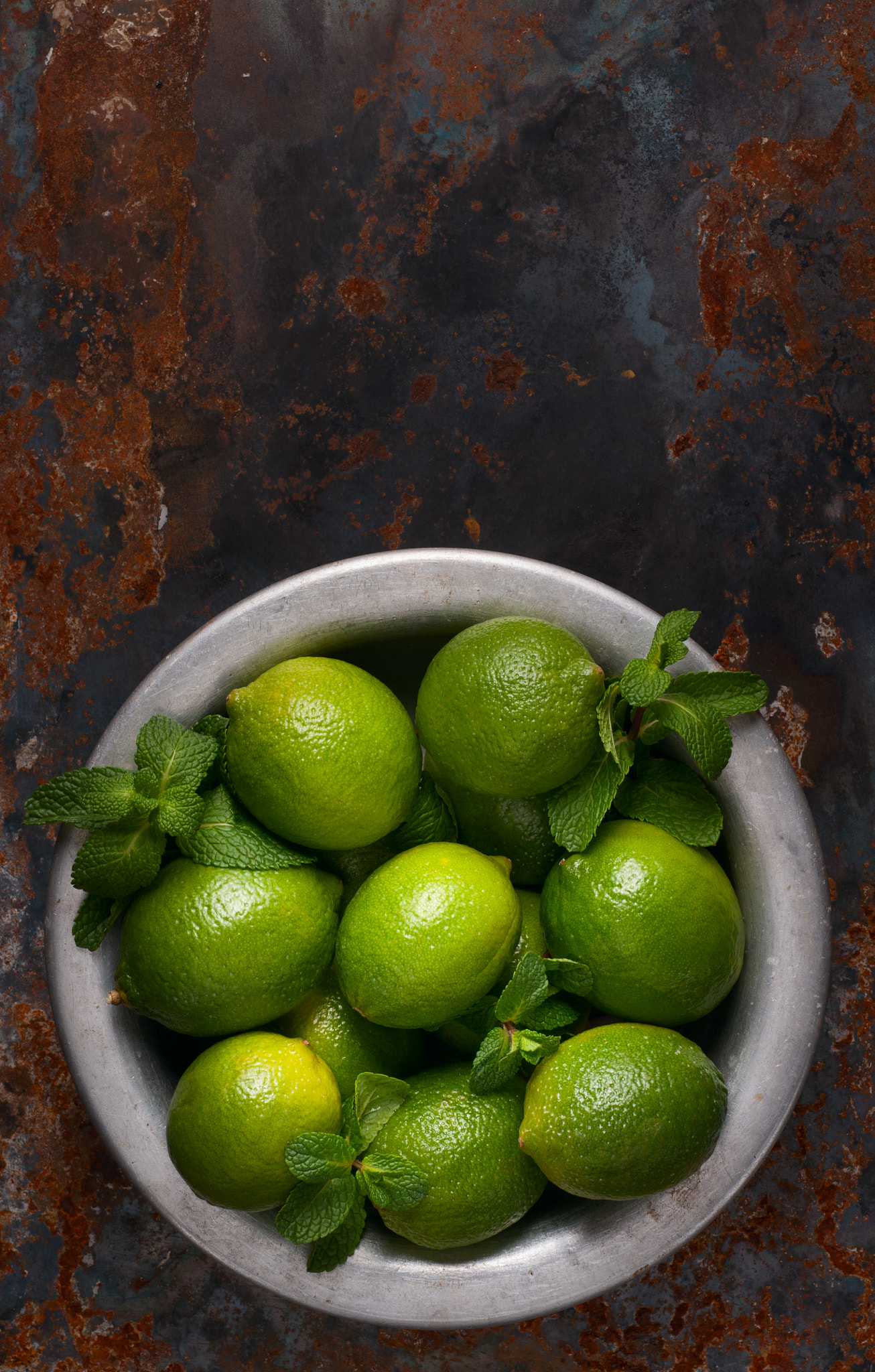 Nikon D90 + Nikon AF Micro-Nikkor 60mm F2.8D sample photo. Fresh lime and mint leaves in an aluminum bowl on a rusty metallic background photography