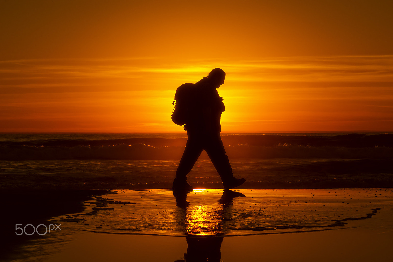 Nikon D600 + Nikon AF-S Nikkor 80-400mm F4.5-5.6G ED VR sample photo. Man walks on the beach at sunset in oceanside. photography
