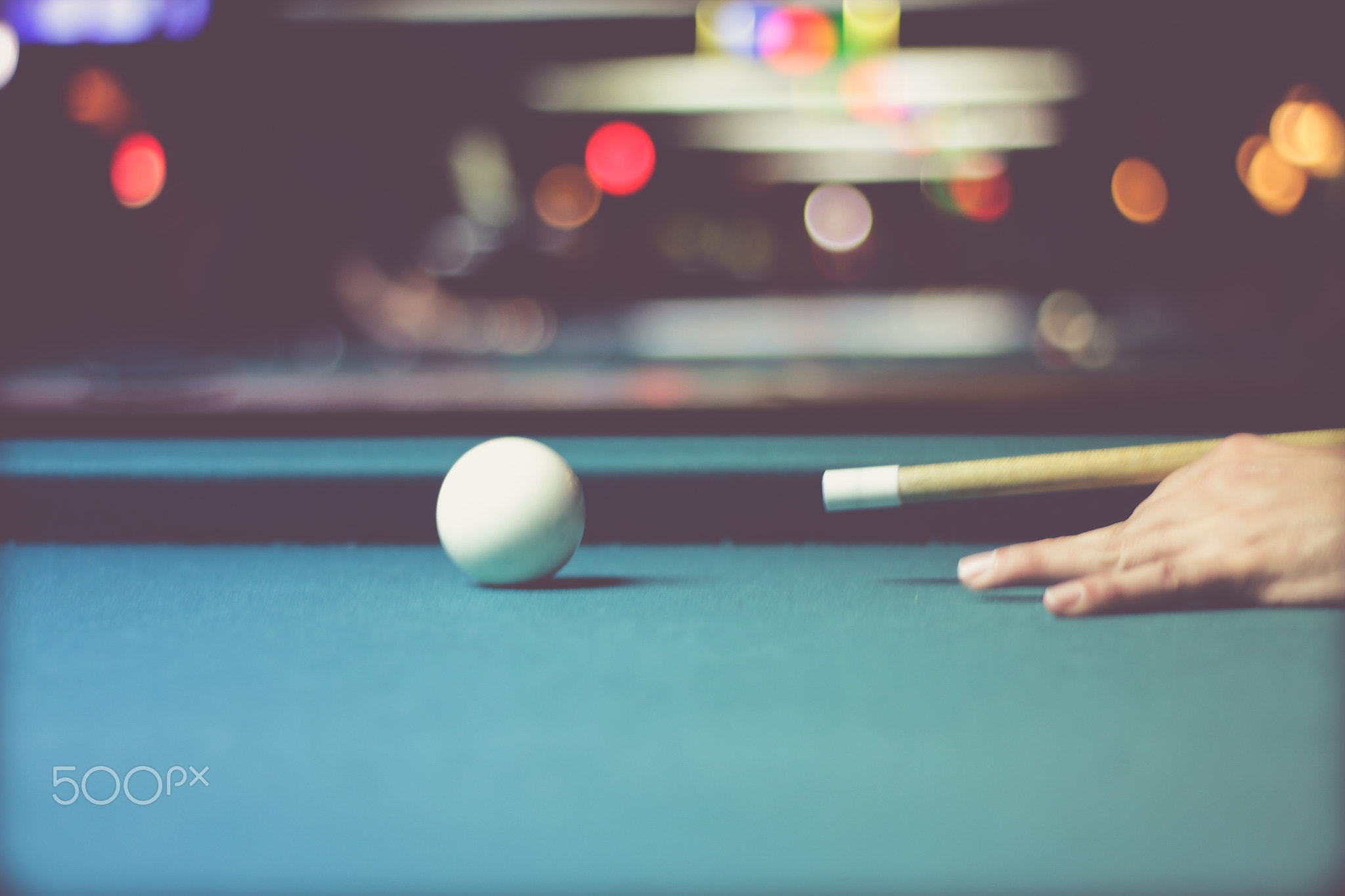 Closeup of hand of man playing pool