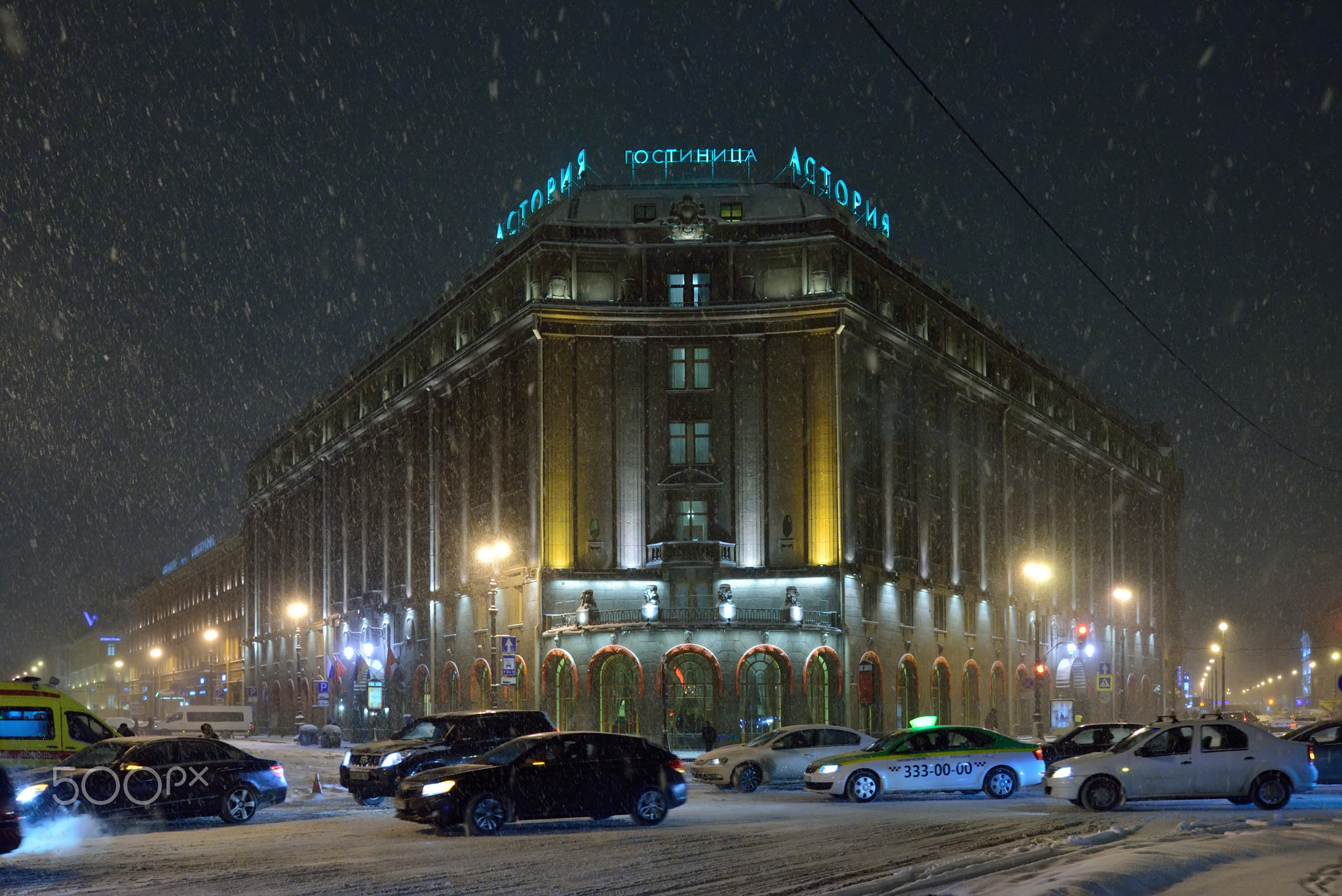 Astoria hotel and the traffic jam in the snow  night