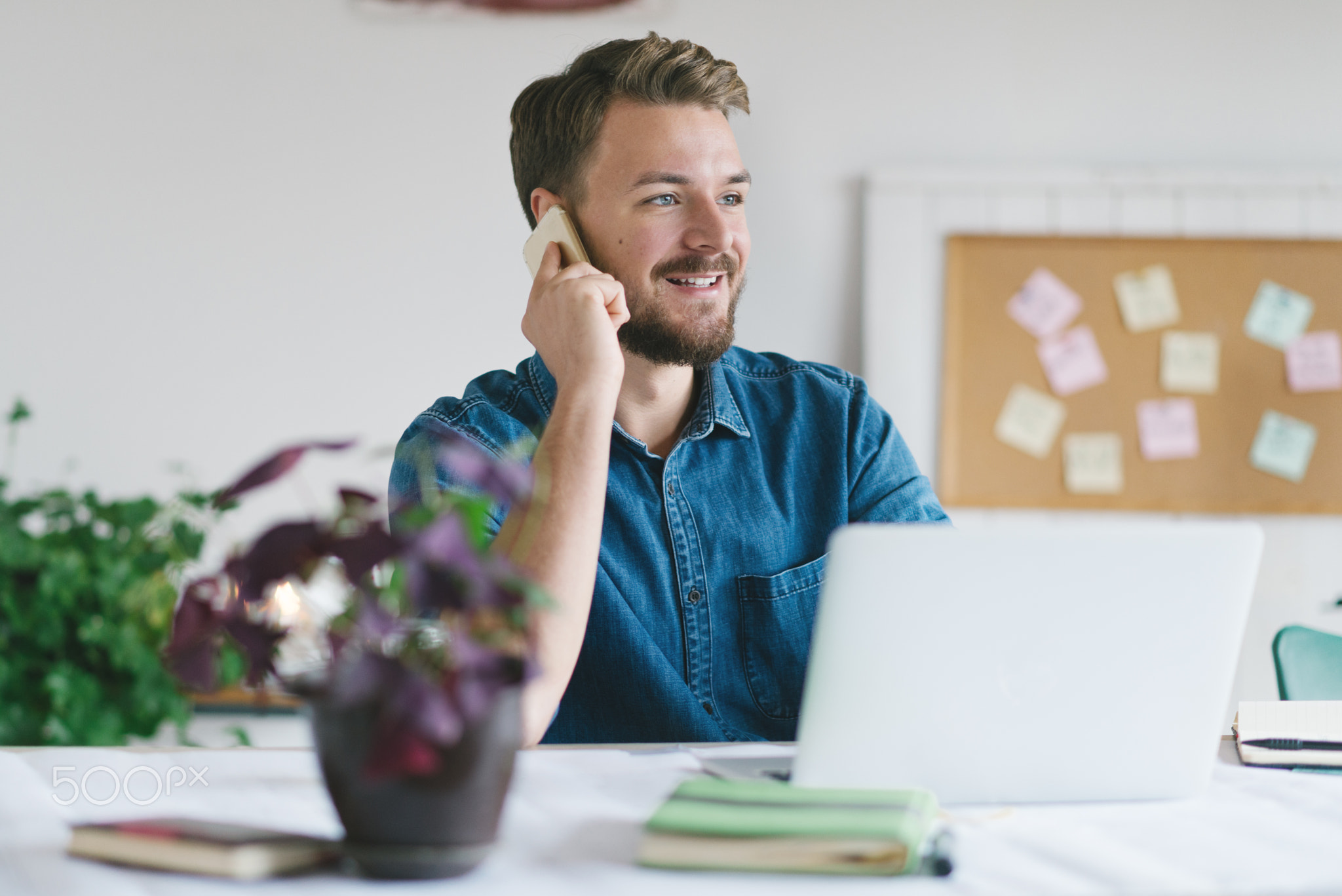 Young smiling businessman working in his office