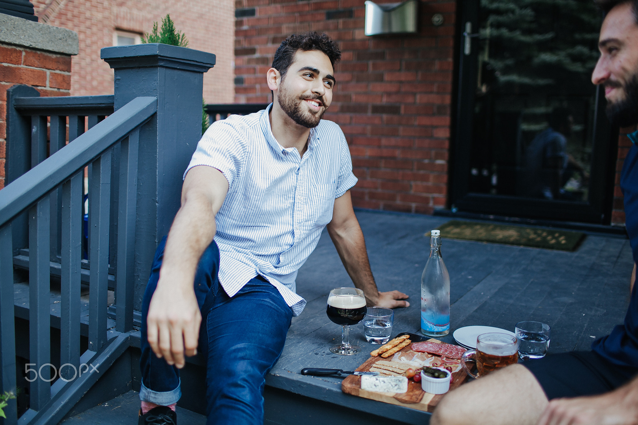 Young men sitting outdoors having a conversation