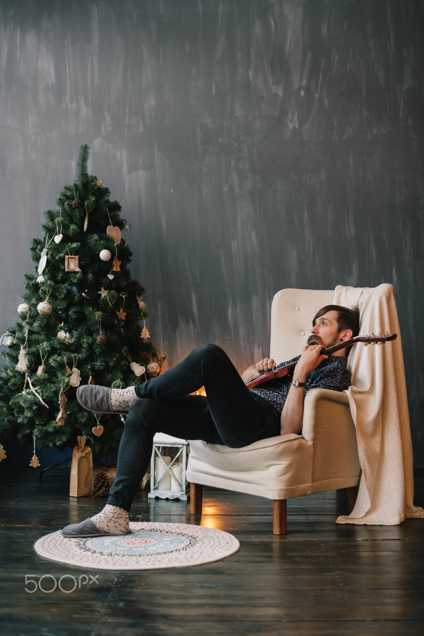 Man playing guitar at xmas eve