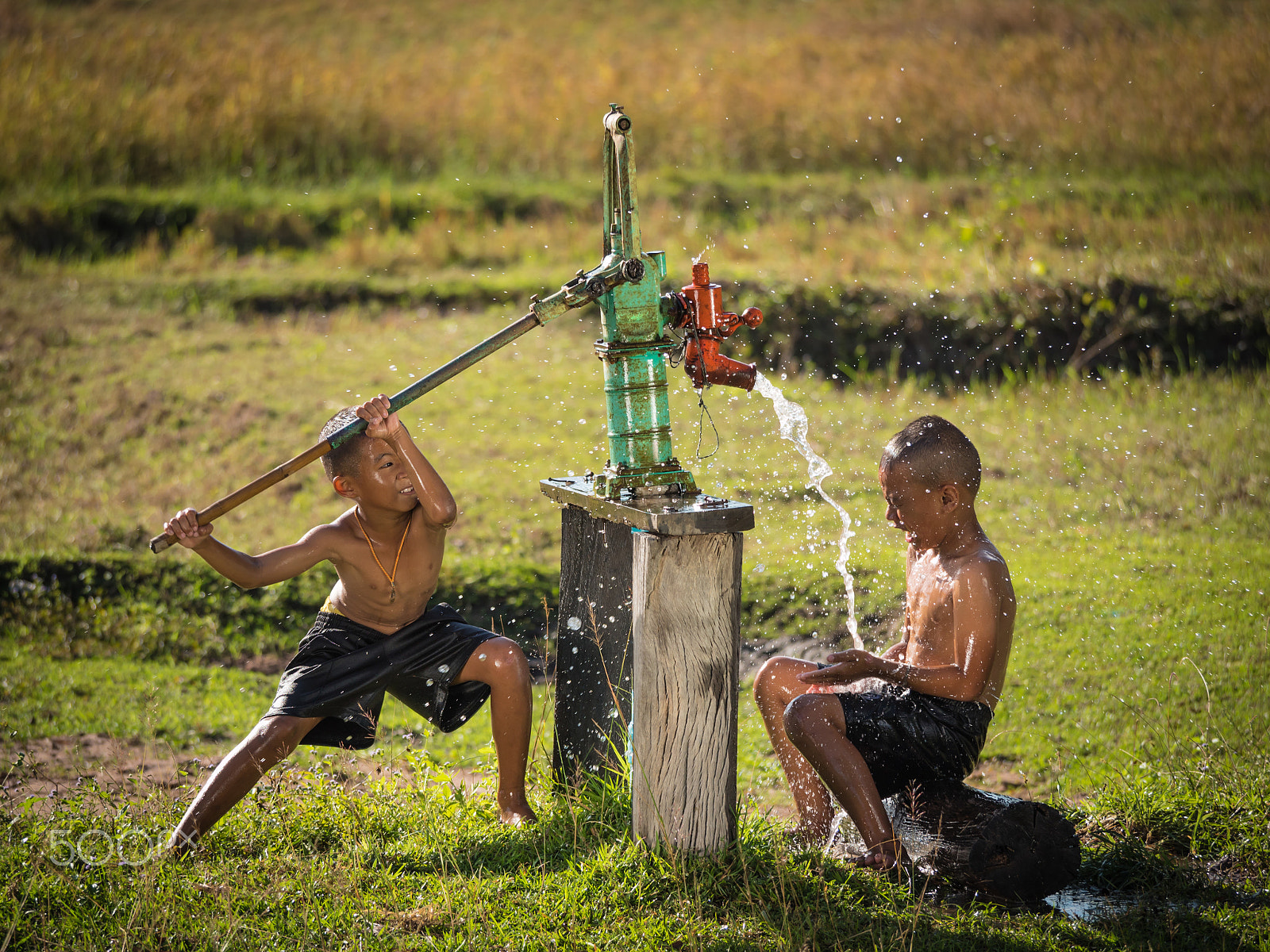 Panasonic Lumix DMC-GH4 sample photo. Two young boy rocking groundwater bathe in the hot days, country photography