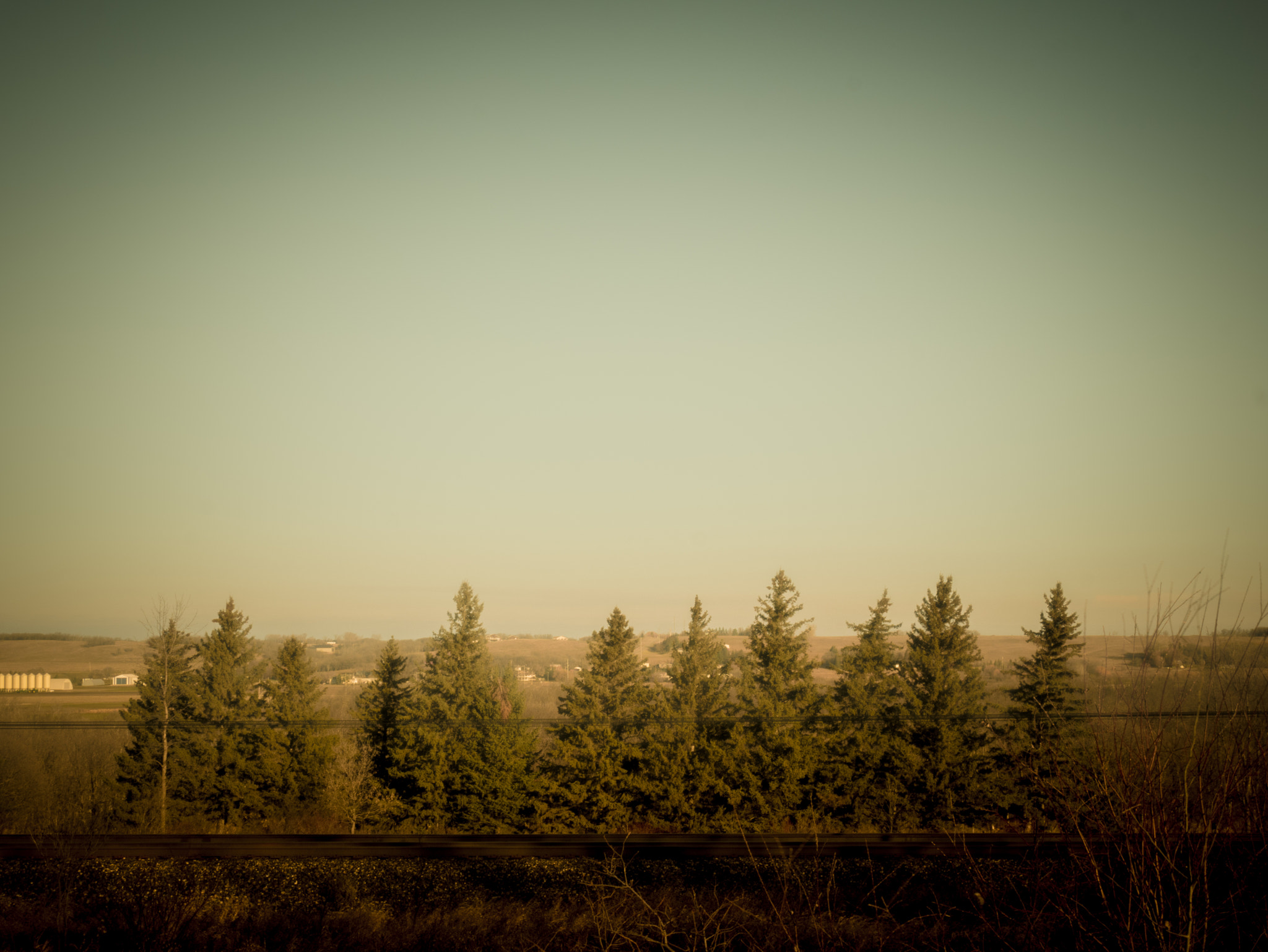 Panasonic Lumix DMC-GF7 sample photo. Tree line, rail line, power lines photography