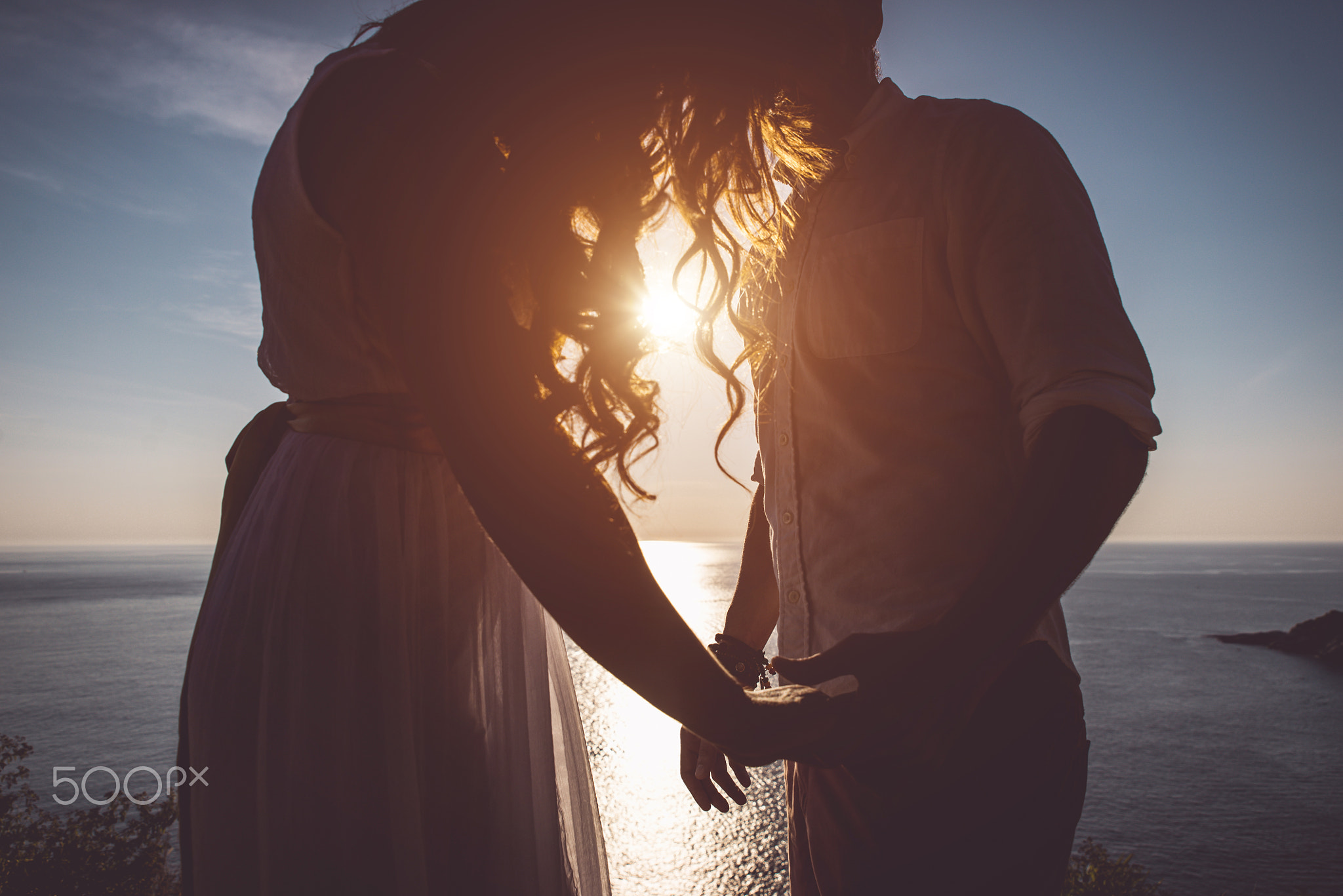 Young couple in love enjoying the view on a cape in Thailand. Ho