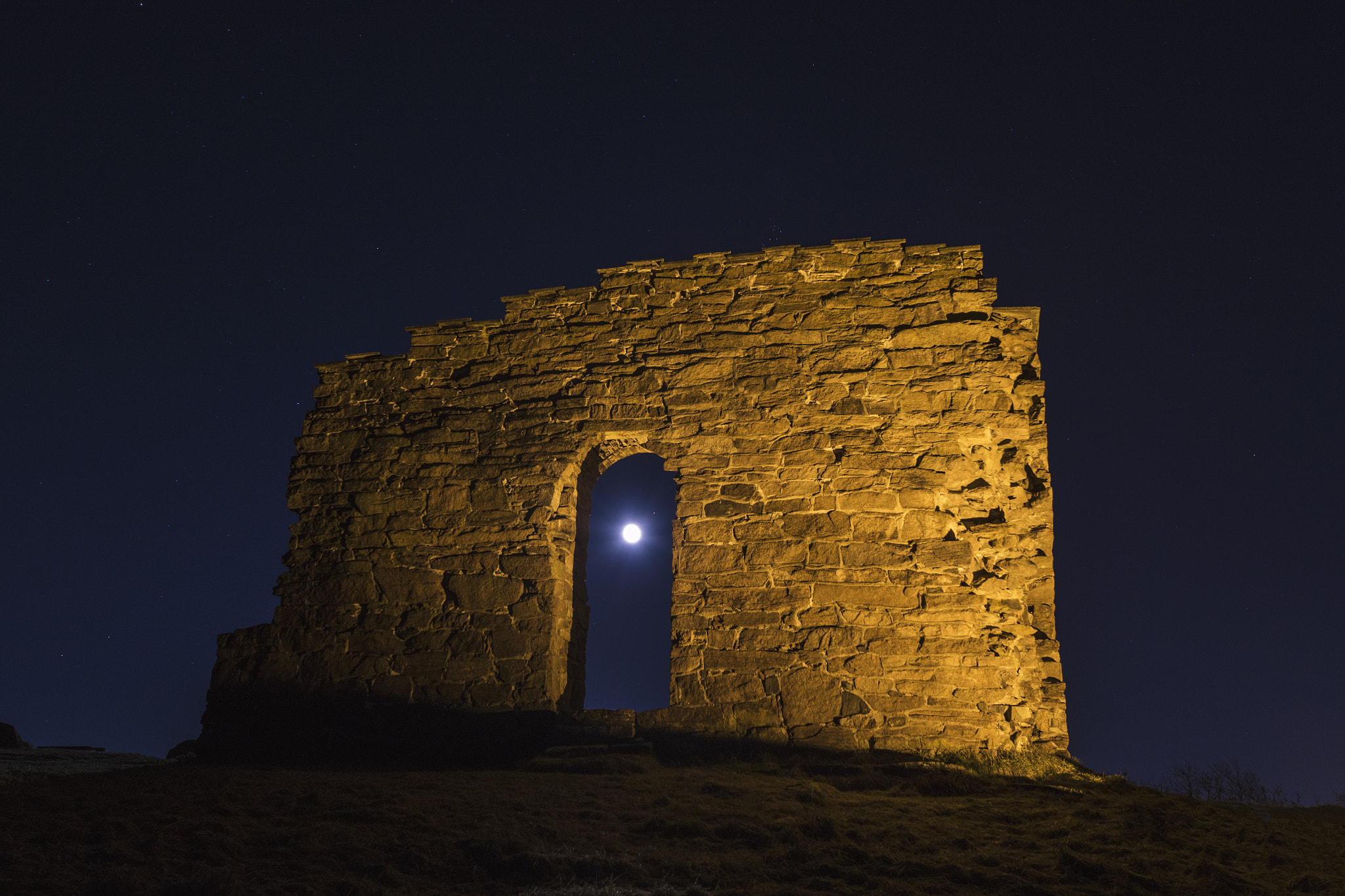 Sigma 20mm F1.4 DG HSM Art sample photo. Almost supermoon thru a door in a church ruin photography