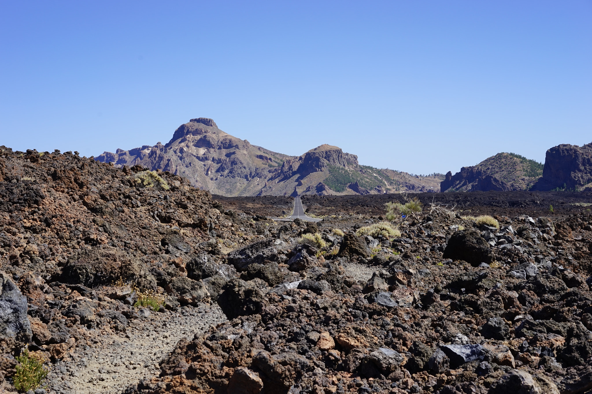 Sony a7 + Sony Sonnar T* FE 55mm F1.8 ZA sample photo. Street cross volcanic rock photography