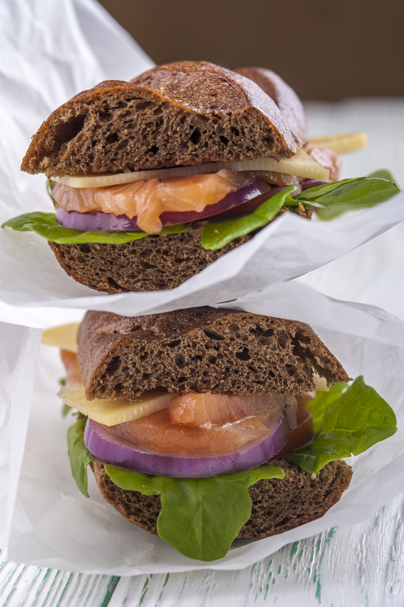 Nikon D700 + AF Micro-Nikkor 105mm f/2.8 sample photo. Two rye bread sandwiches with salmon, vegetables and lettuce photography