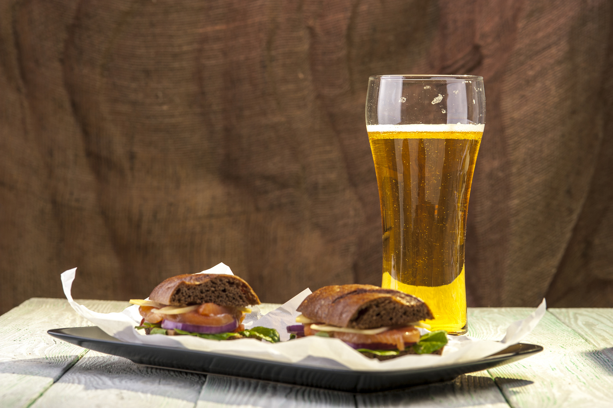Nikon D700 sample photo. Black plate with sandwiches and beer glass photography