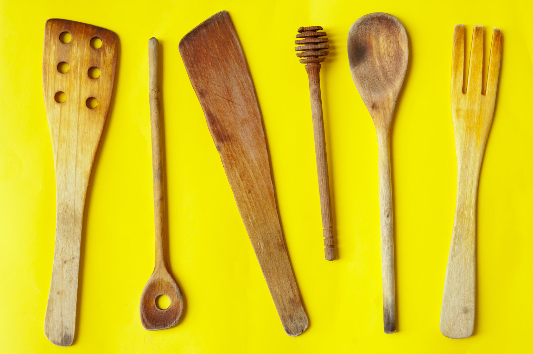 Nikon D2X sample photo. Old wooden spoons and stirrers on yellow background photography