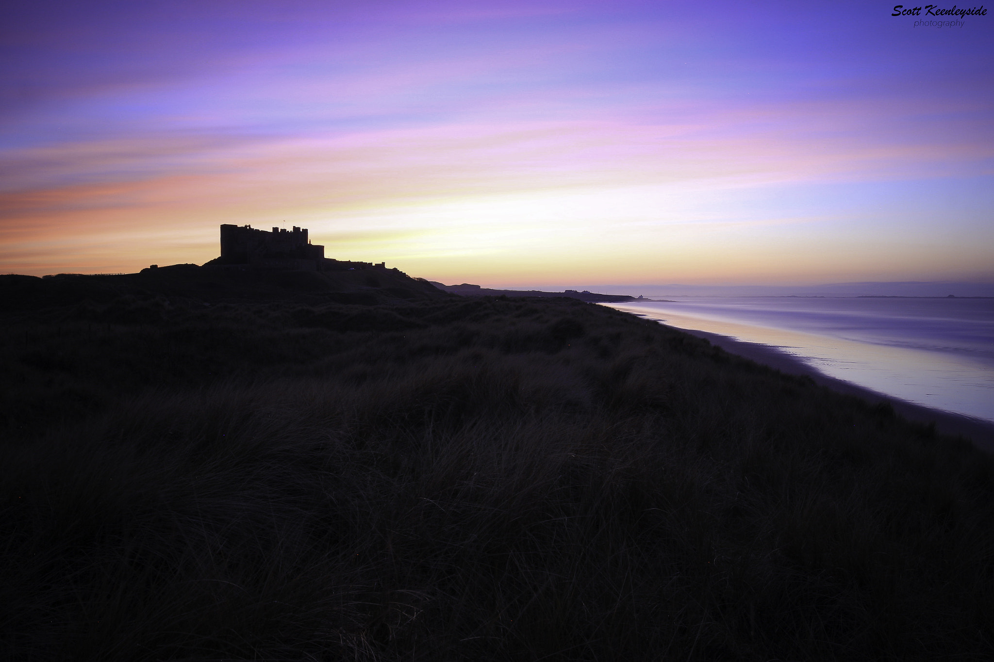 Canon EF 16-35mm F4L IS USM sample photo. Bamburgh castle sunset, northumberland coast. photography