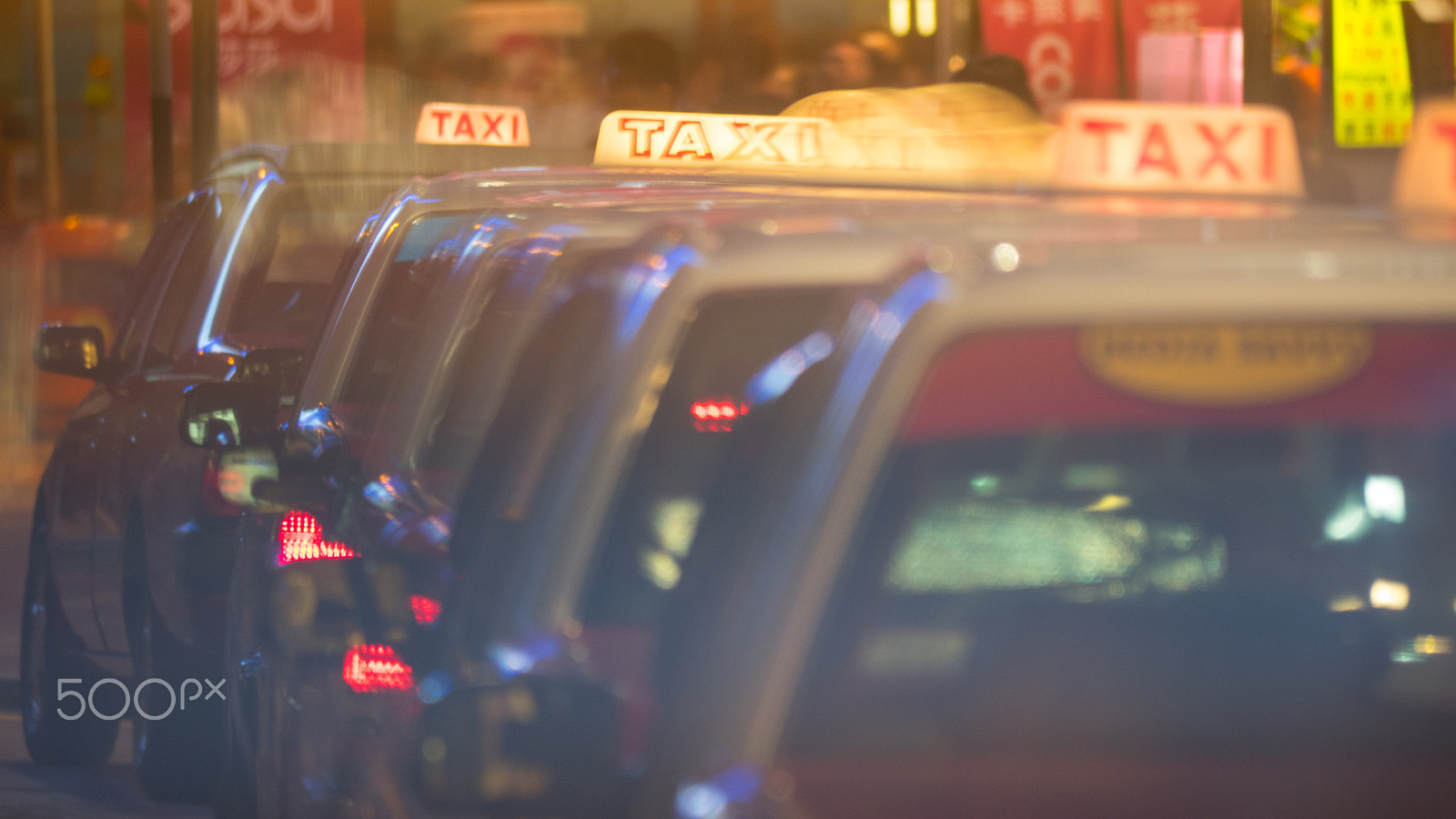 Panasonic Lumix DMC-GH4 sample photo. Row of taxi cars in night street photography