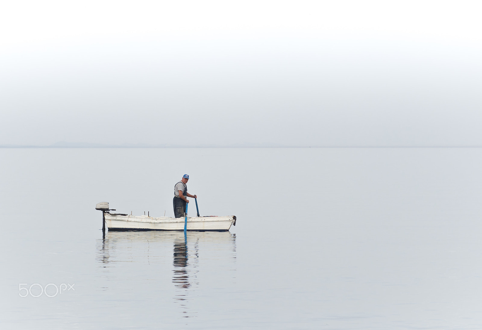 Olympus OM-D E-M5 sample photo. Standing man in boat photography