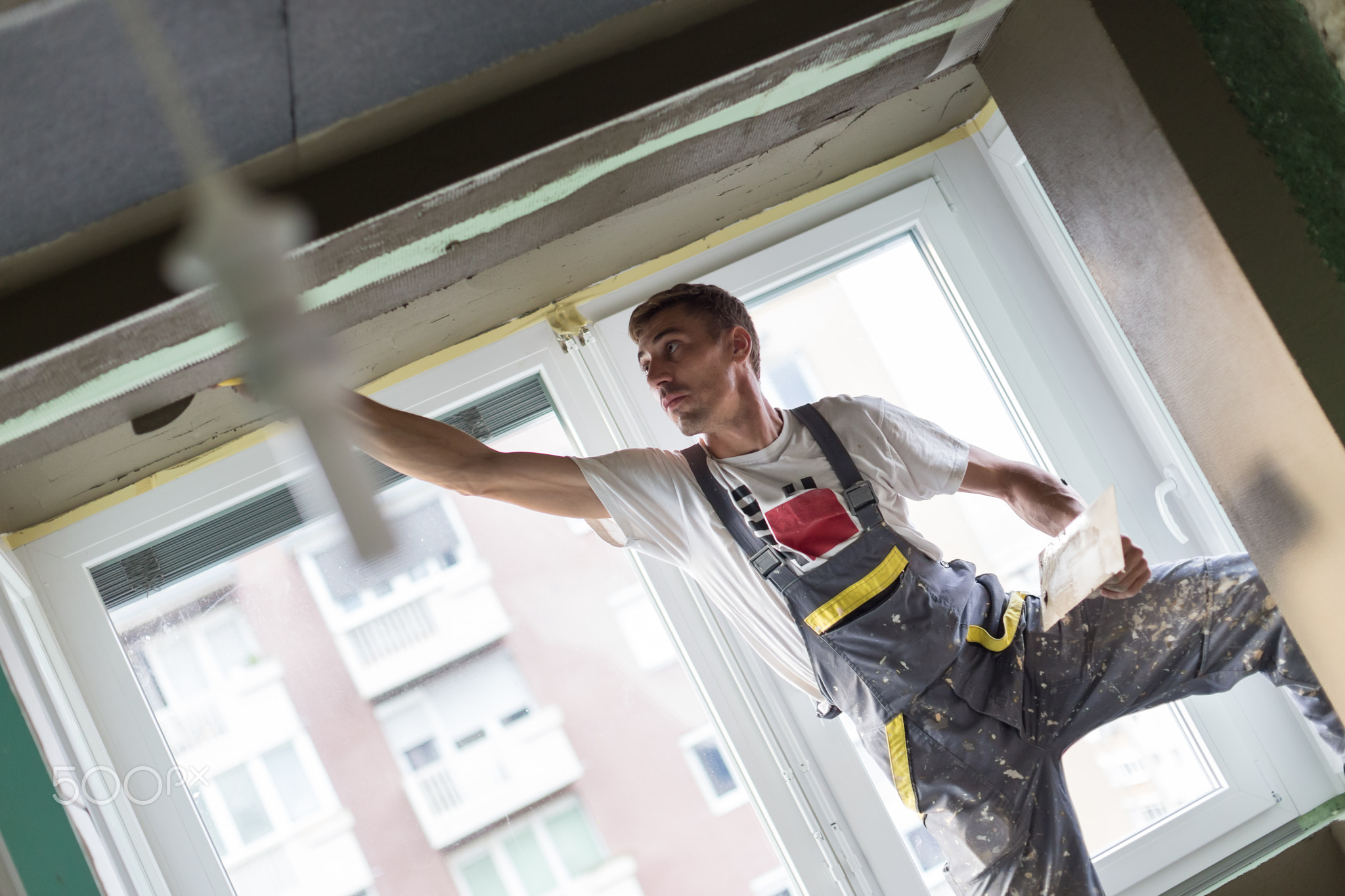 Plasterer renovating indoor walls and ceilings. Finishing works.