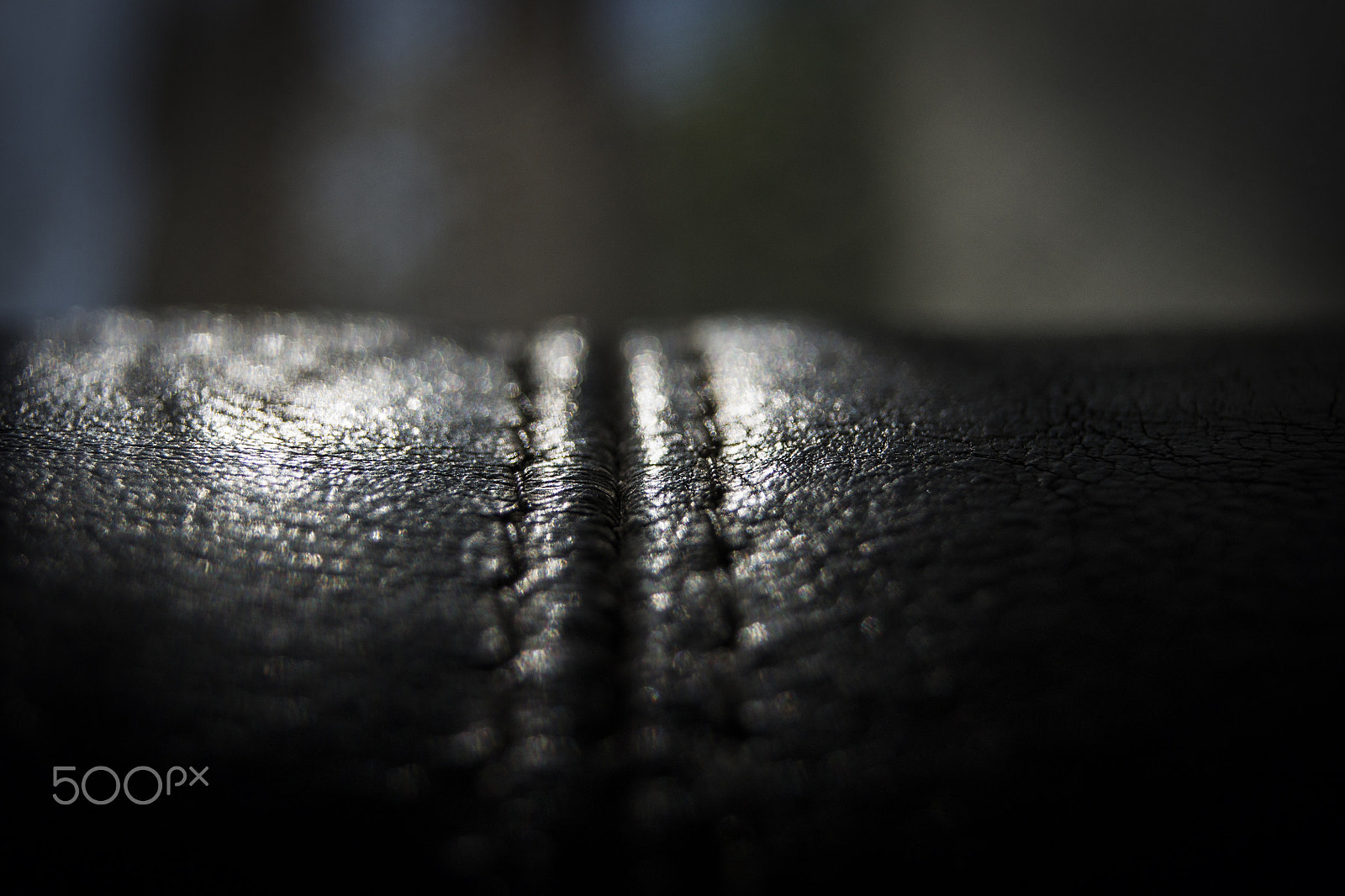 Sony Alpha DSLR-A500 sample photo. Black leather couch closeup photography