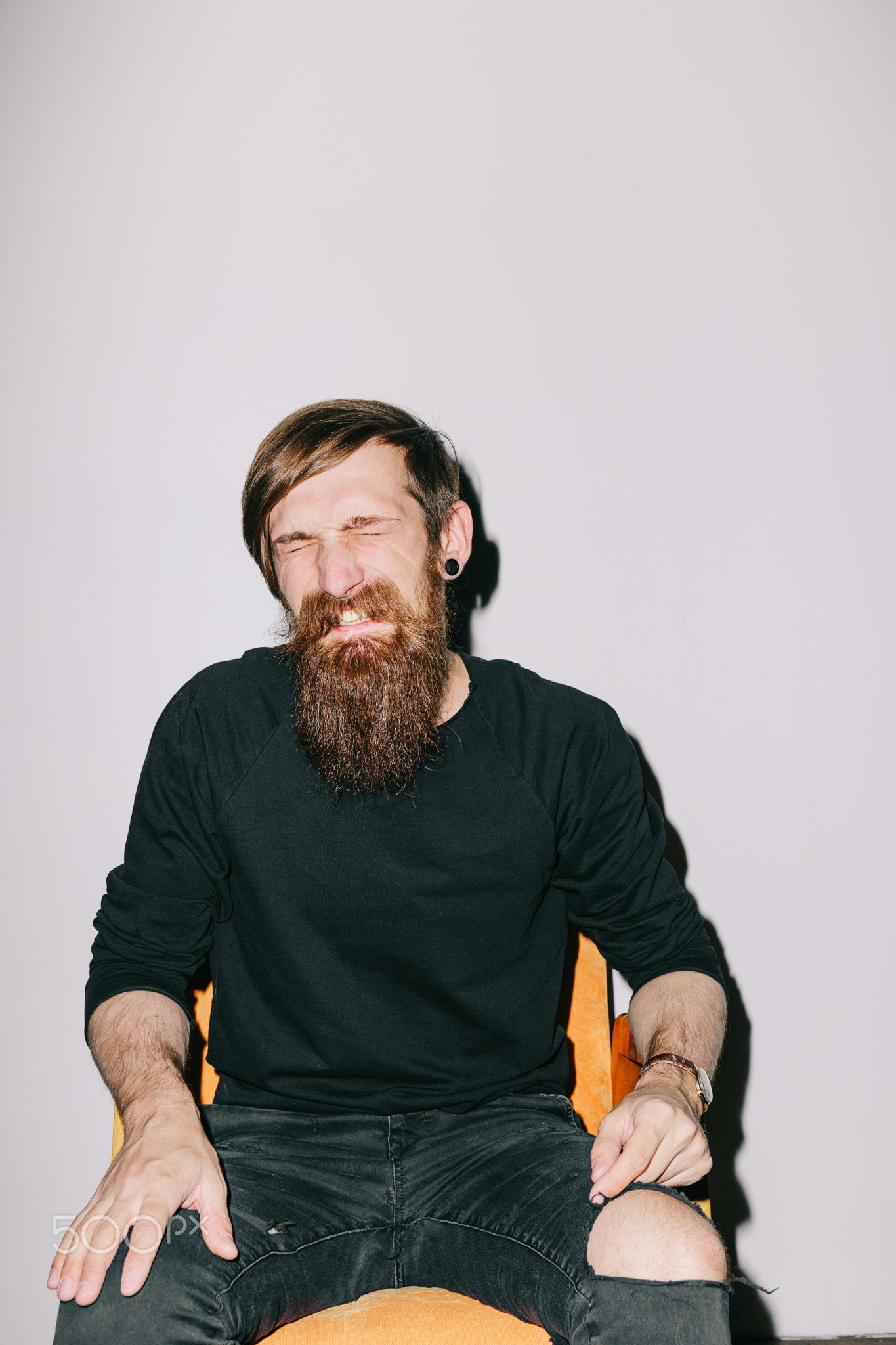 Bearded man sitting at chair