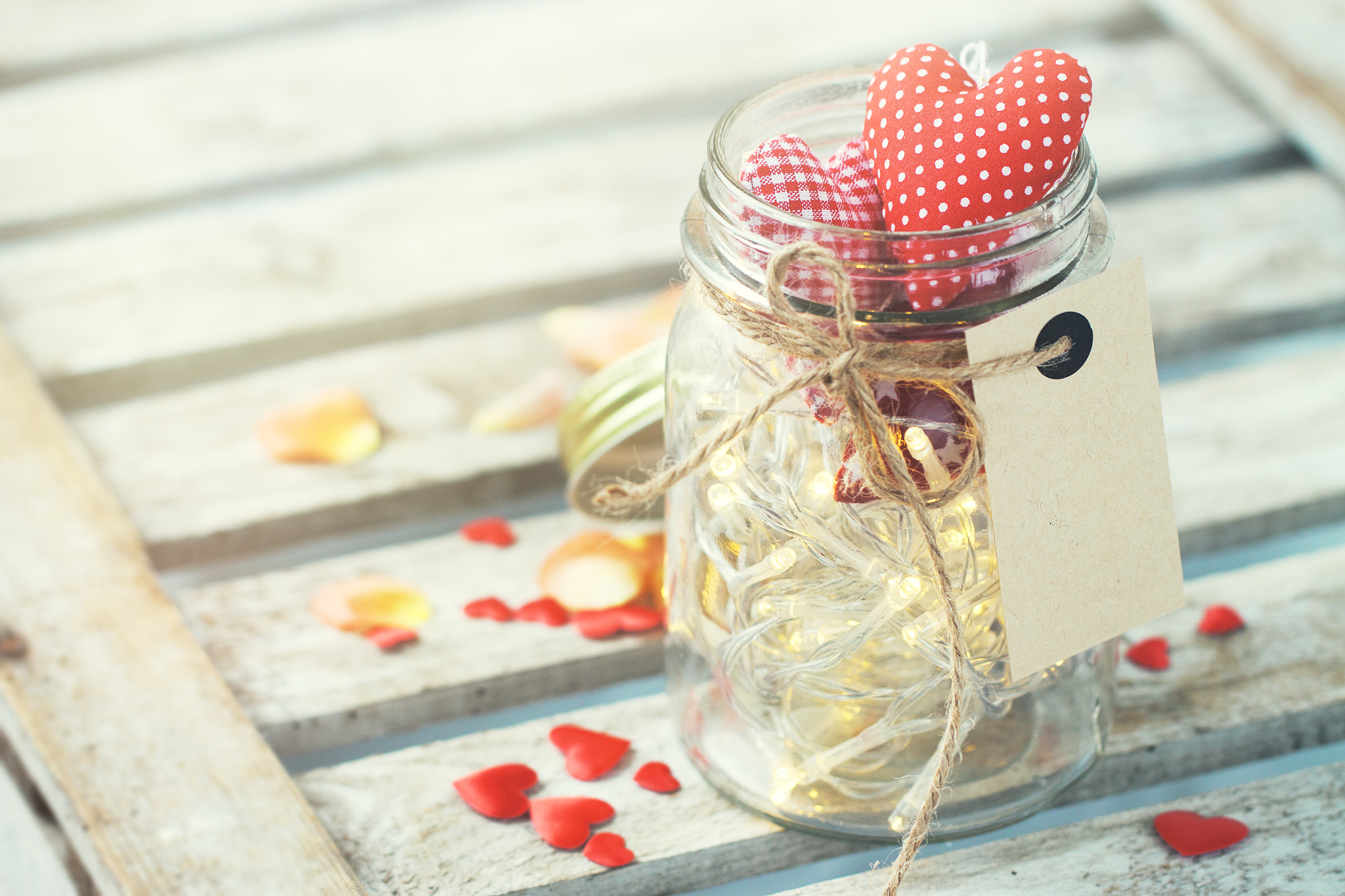 Beautiful lights, garland in a jar with textile red plush hearts