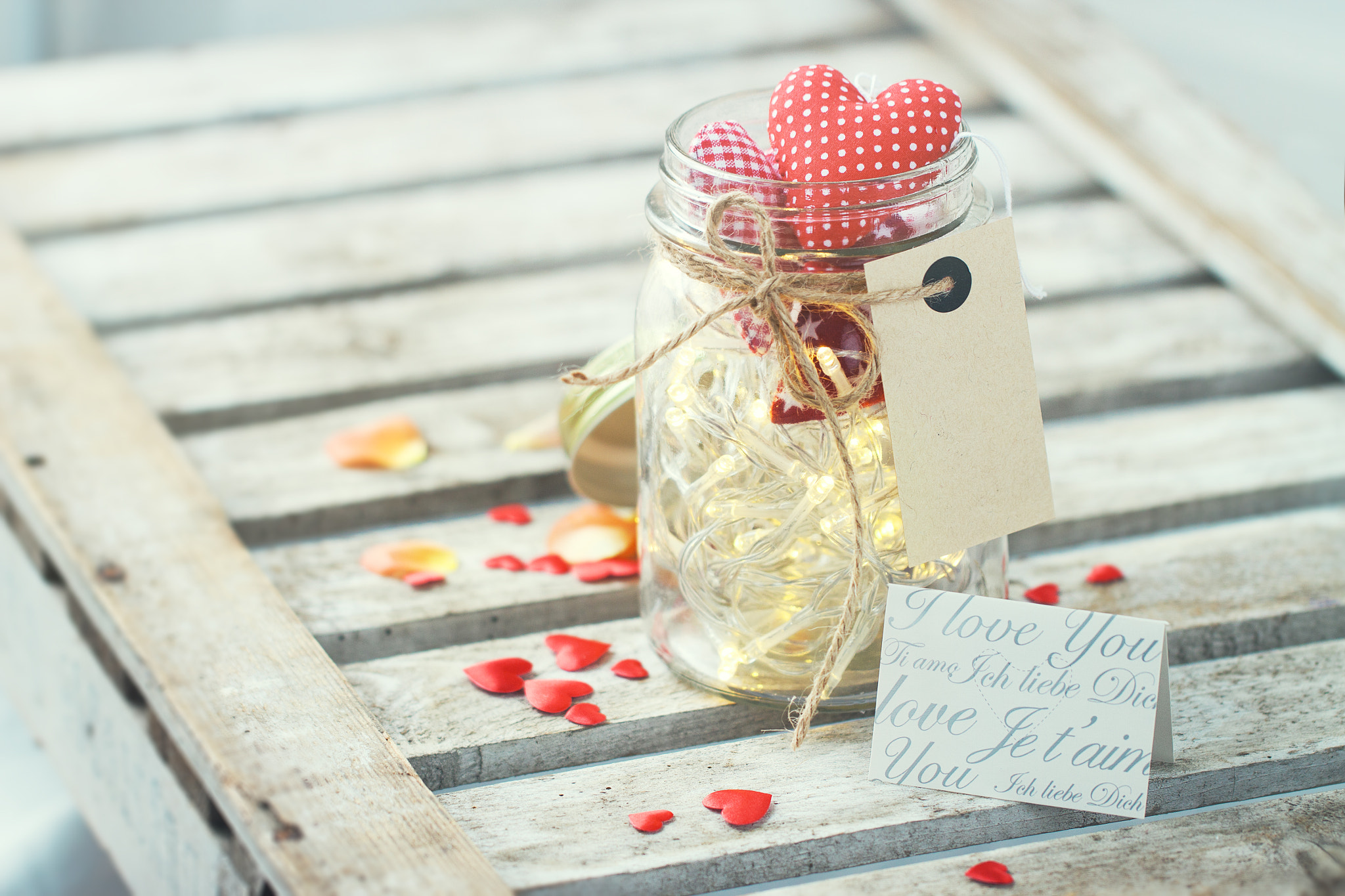 Beautiful lights, garland in a jar with textile red plush hearts
