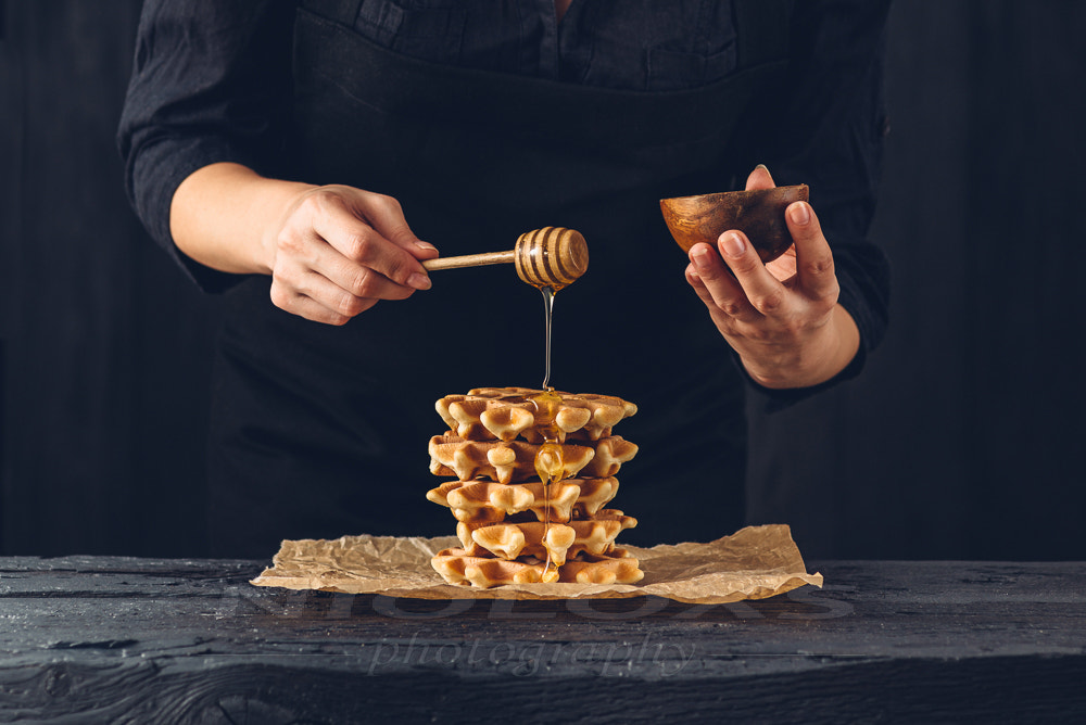 Nikon D610 sample photo. Woman pouring honey on waffles photography
