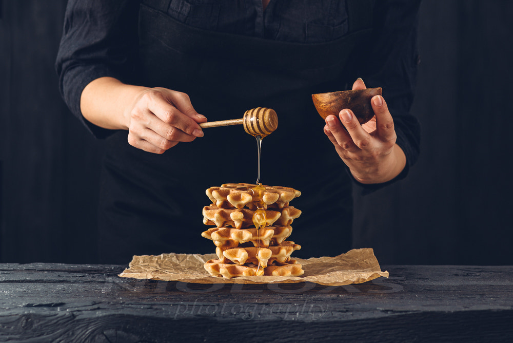 Tokina AT-X Pro 100mm F2.8 Macro sample photo. Woman pouring honey on waffles photography