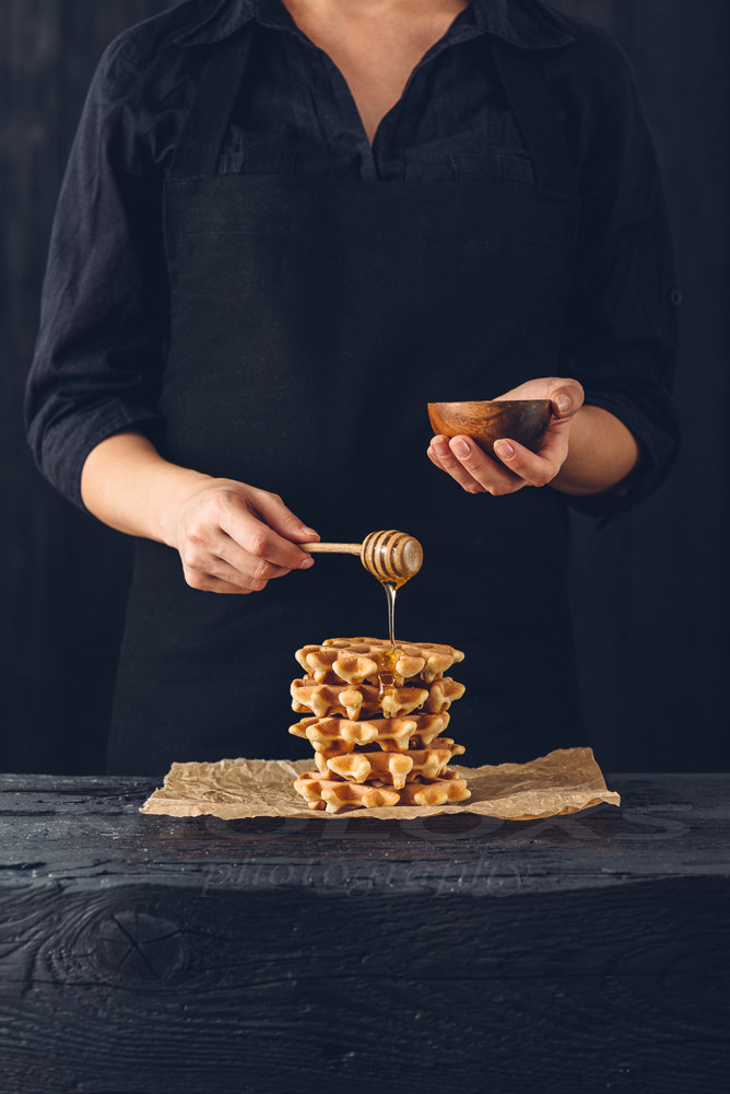 Nikon D610 sample photo. Woman pouring honey on waffles photography