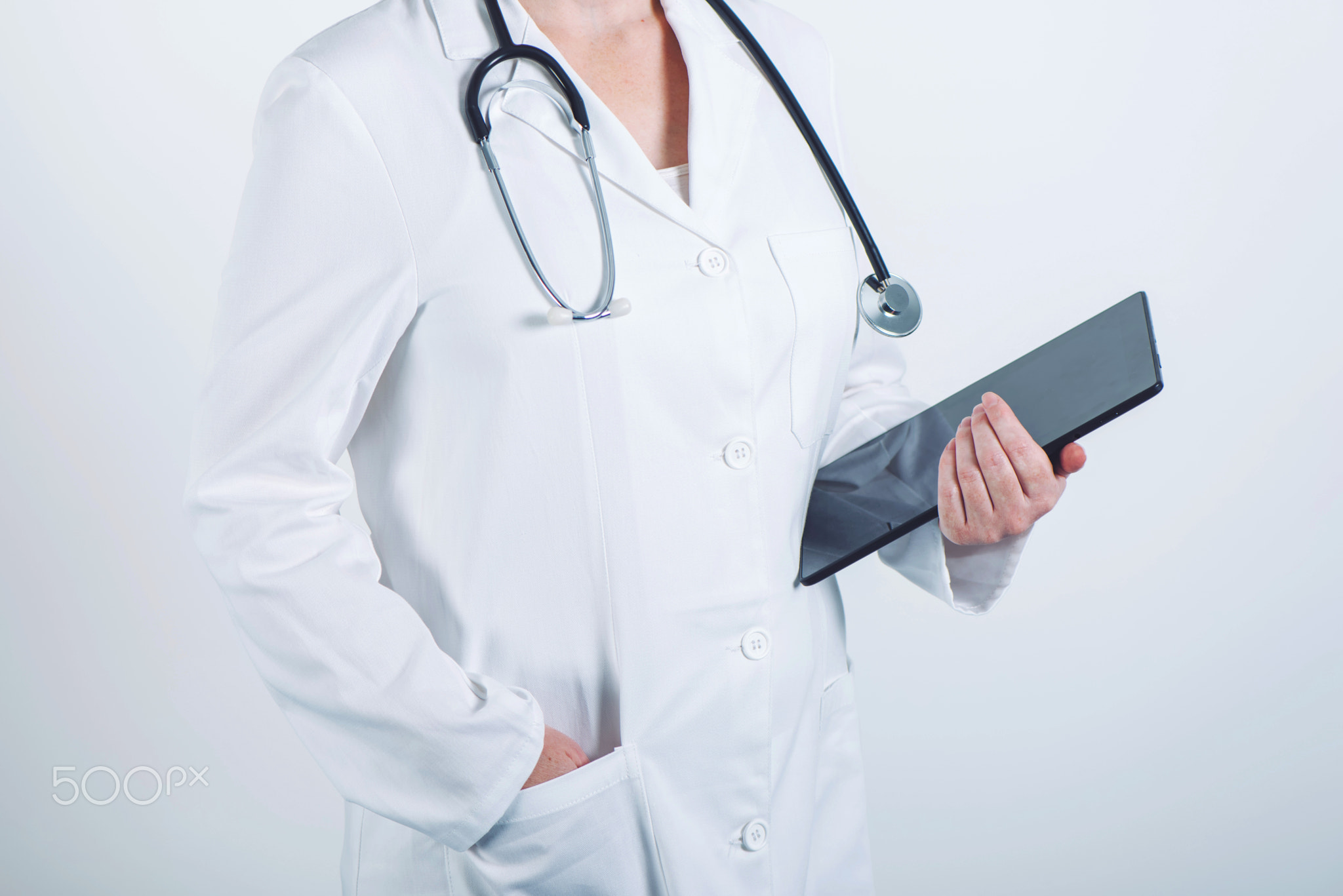 Female doctor posing with tablet computer