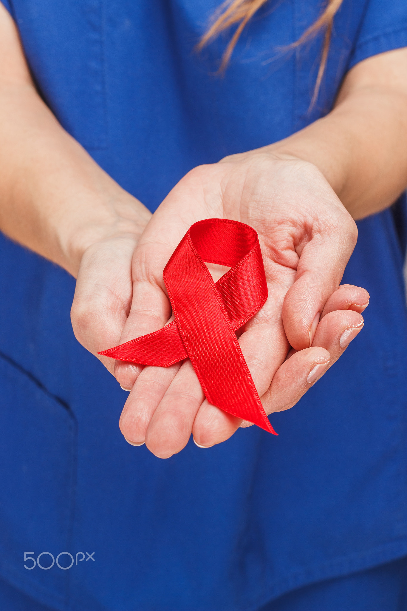 Red ribbon in the woman palms