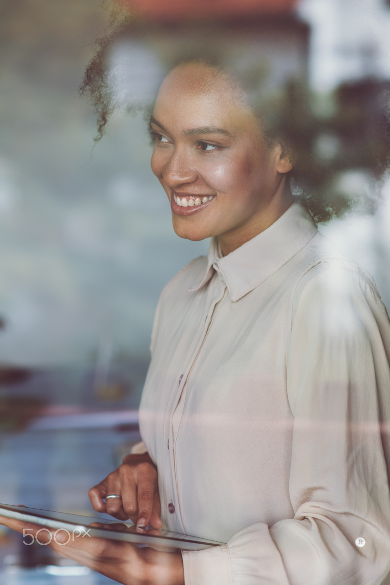 Smiling woman using tablet, double exposure photo