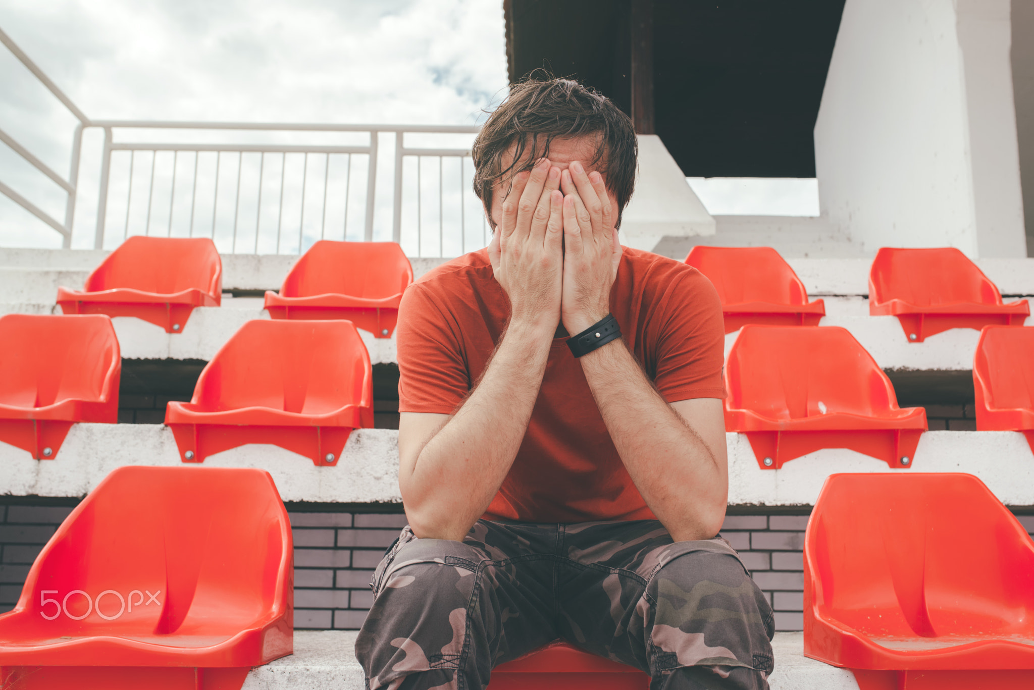 Disappointed man at sport stadium watching the game