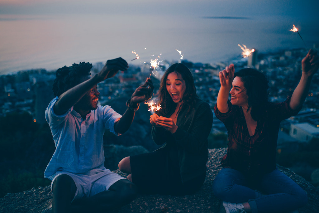 Group of friends celebrating with sparklers at night by Carina König on 500px.com