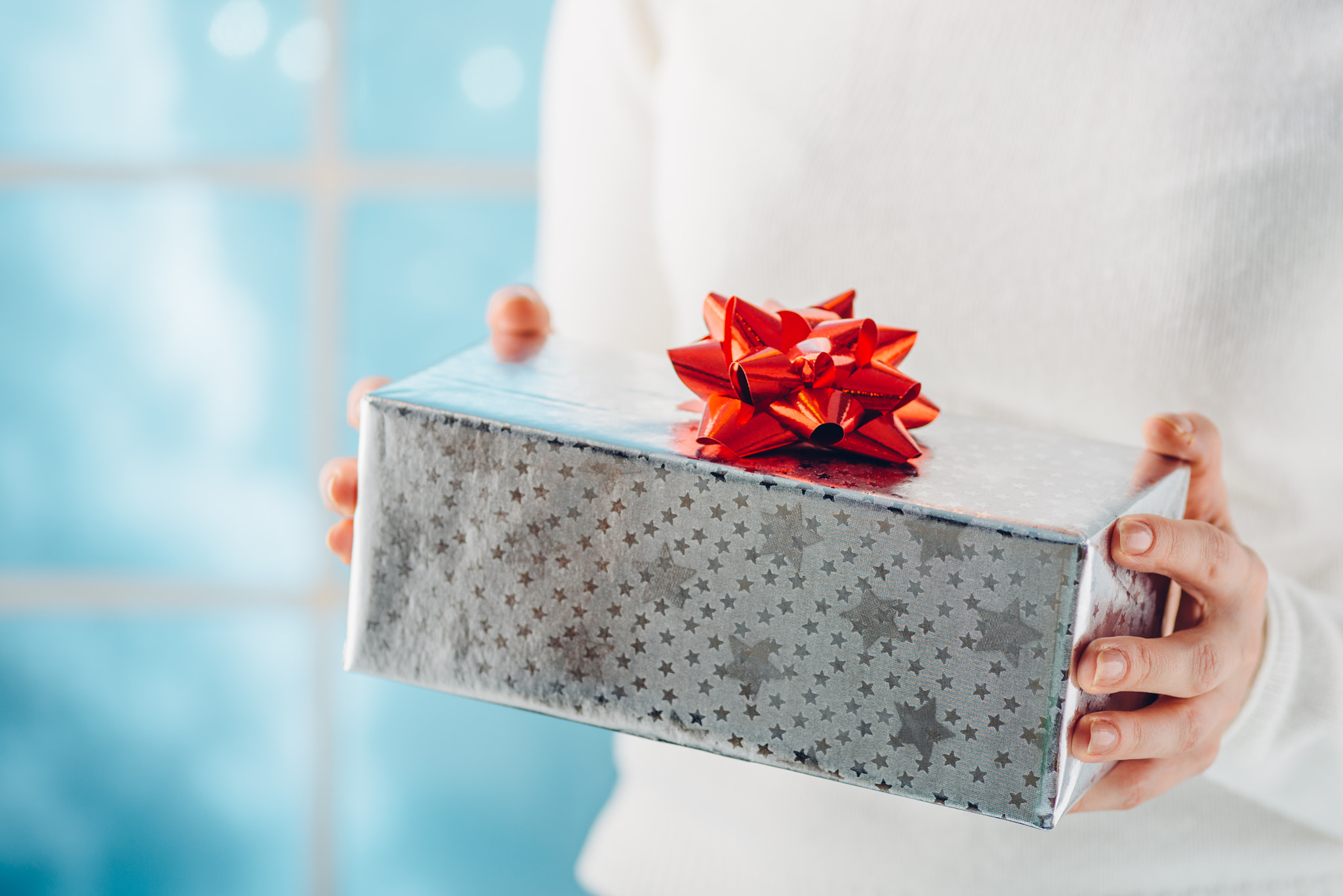 Christmas gift in the hands of woman. Shallow dof