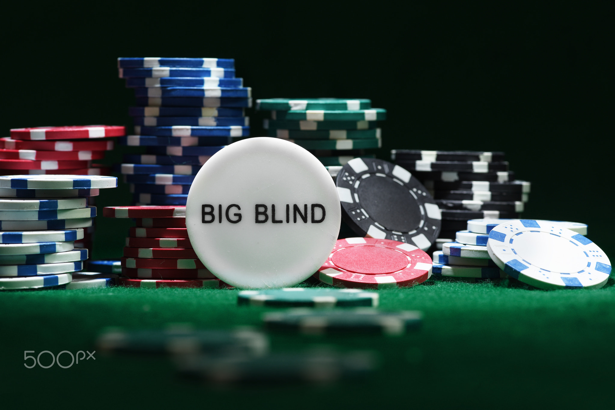Close up shot of group poker chips on green table