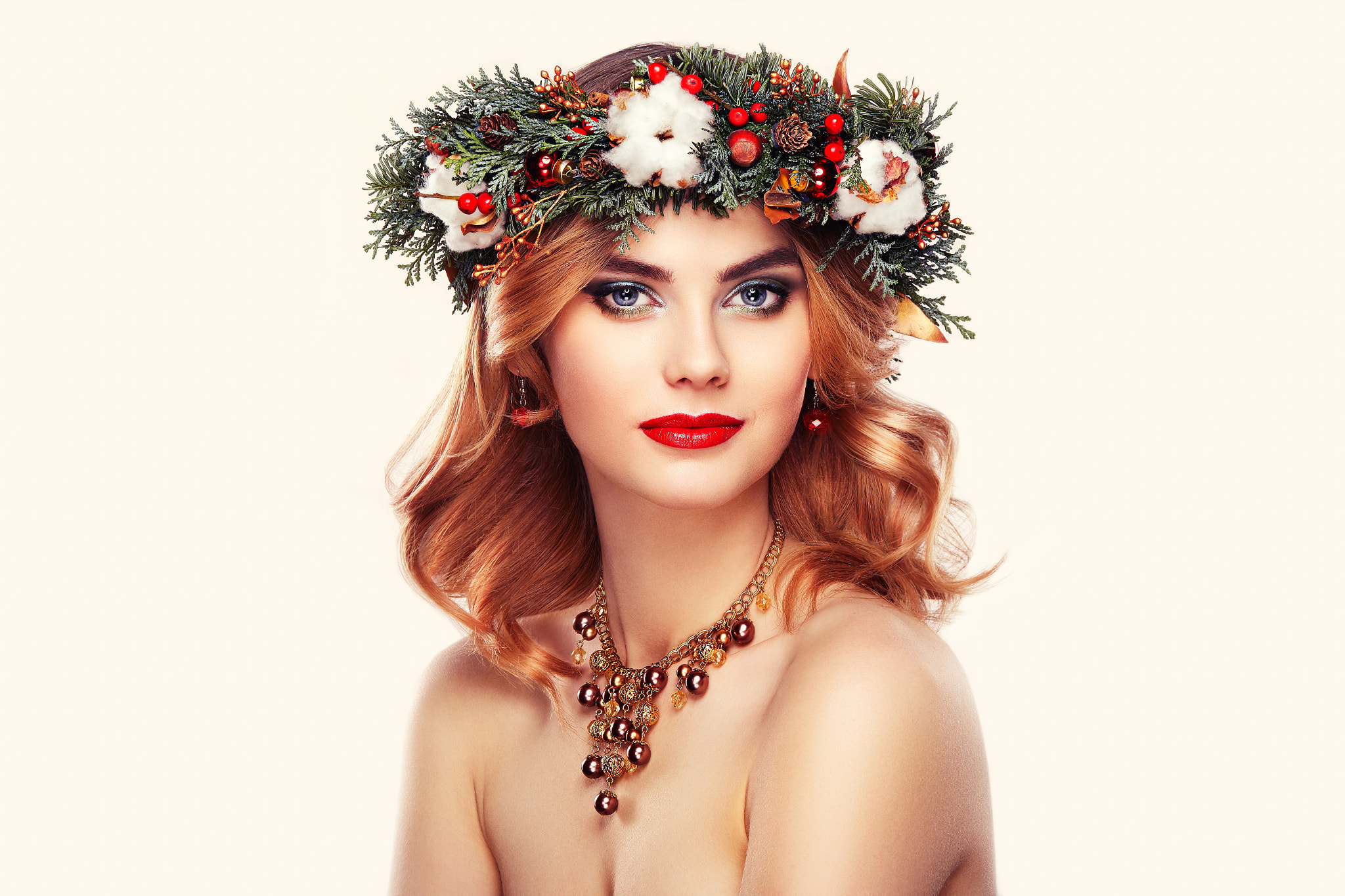 Portrait of beautiful young woman with Christmas wreath