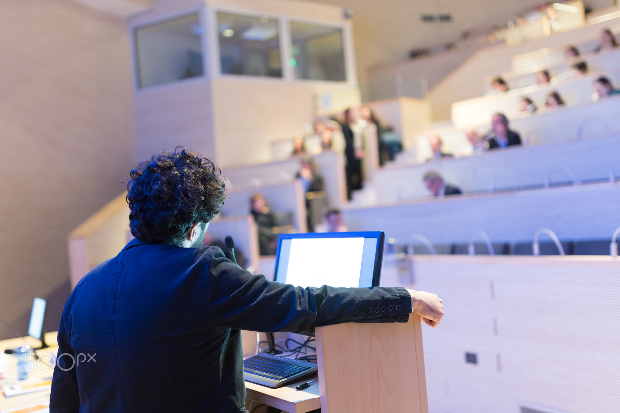 Speaker giving talk on at Business Conference.