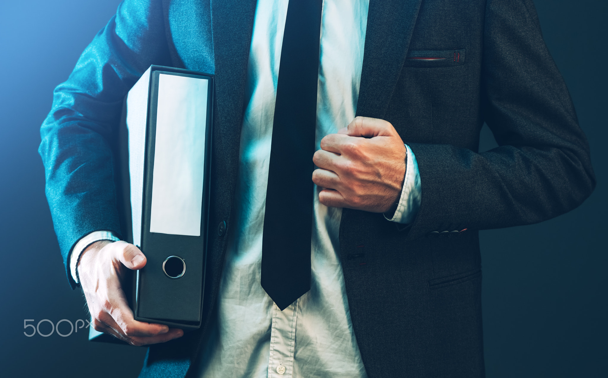 Businessman with corporate files in document binder